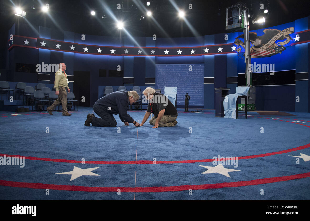 Set designer Michael Foley and set builder Peter Crawford work int he debate hall in preparation for the Presidential debate between Democratic candidate Hillary Clinton and Republican candidate Donald Trump, at Washington University in St. Louis on October 8, 2016. Clinton and Trump will face off tomorrow night in the second to last Presidential debate. Photo by Kevin Dietsch/UPI Stock Photo