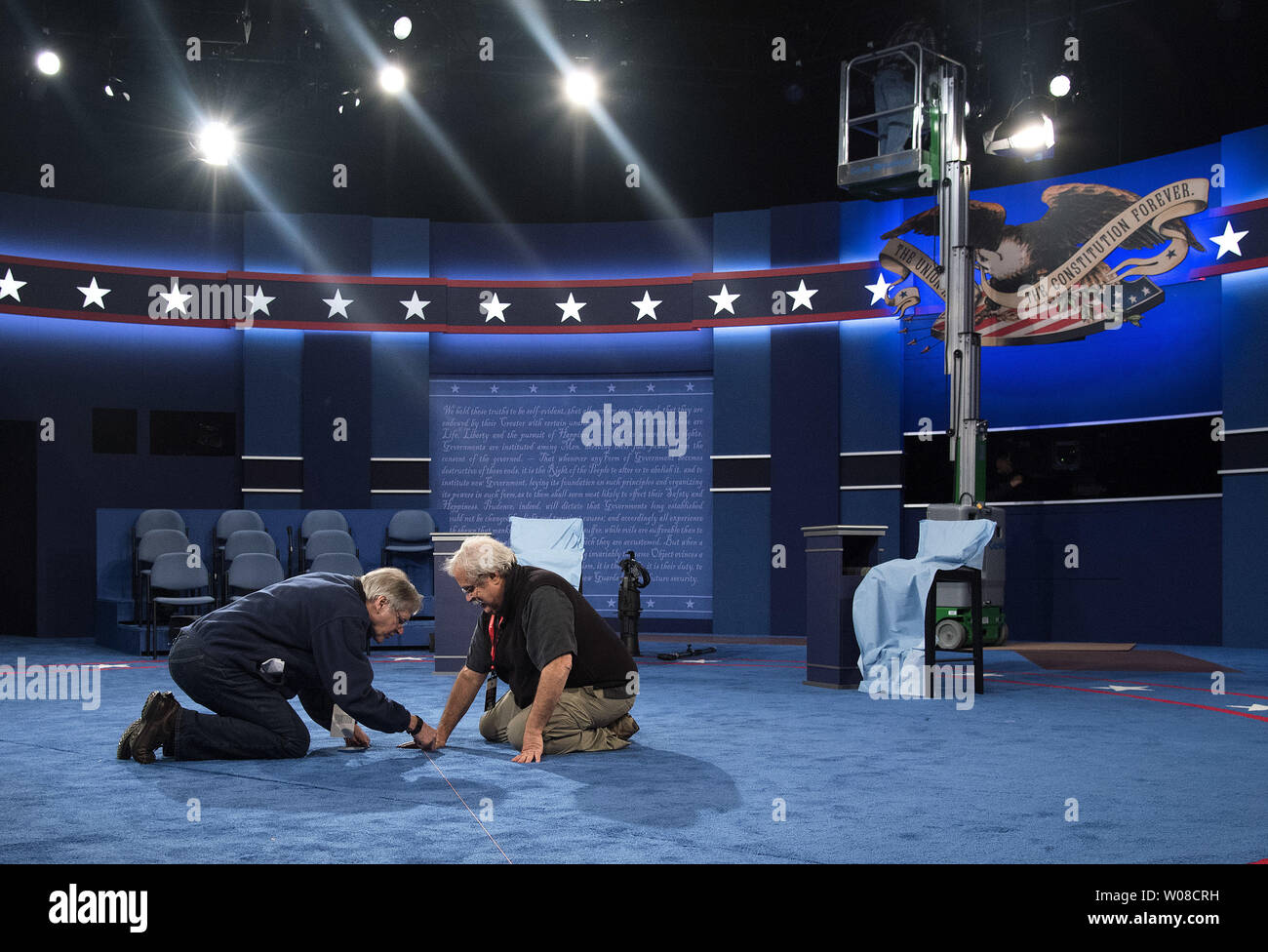 Set designer Michael Foley and set builder Peter Crawford work int he debate hall in preparation for the Presidential debate between Democratic candidate Hillary Clinton and Republican candidate Donald Trump, at Washington University in St. Louis on October 8, 2016. Clinton and Trump will face off tomorrow night in the second to last Presidential debate. Photo by Kevin Dietsch/UPI Stock Photo