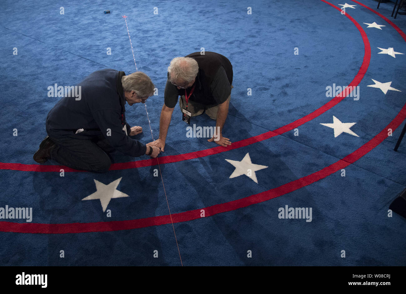 Set designer Michael Foley and set builder Peter Crawford work int he debate hall in preparation for the Presidential debate between Democratic candidate Hillary Clinton and Republican candidate Donald Trump, at Washington University in St. Louis on October 8, 2016. Clinton and Trump will face off tomorrow night in the second to last Presidential debate. Photo by Kevin Dietsch/UPI Stock Photo