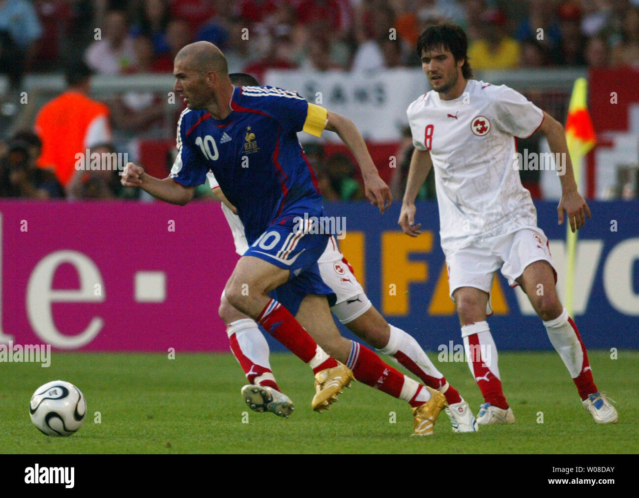 French top star Zinedine Zidane beats two Swiss defenders in World Cup soccer action in Stuttgart, Germany on June 13, 2006. France and Switzerland tied 0-0.  (UPI Photo/Arthur Thill) Stock Photo