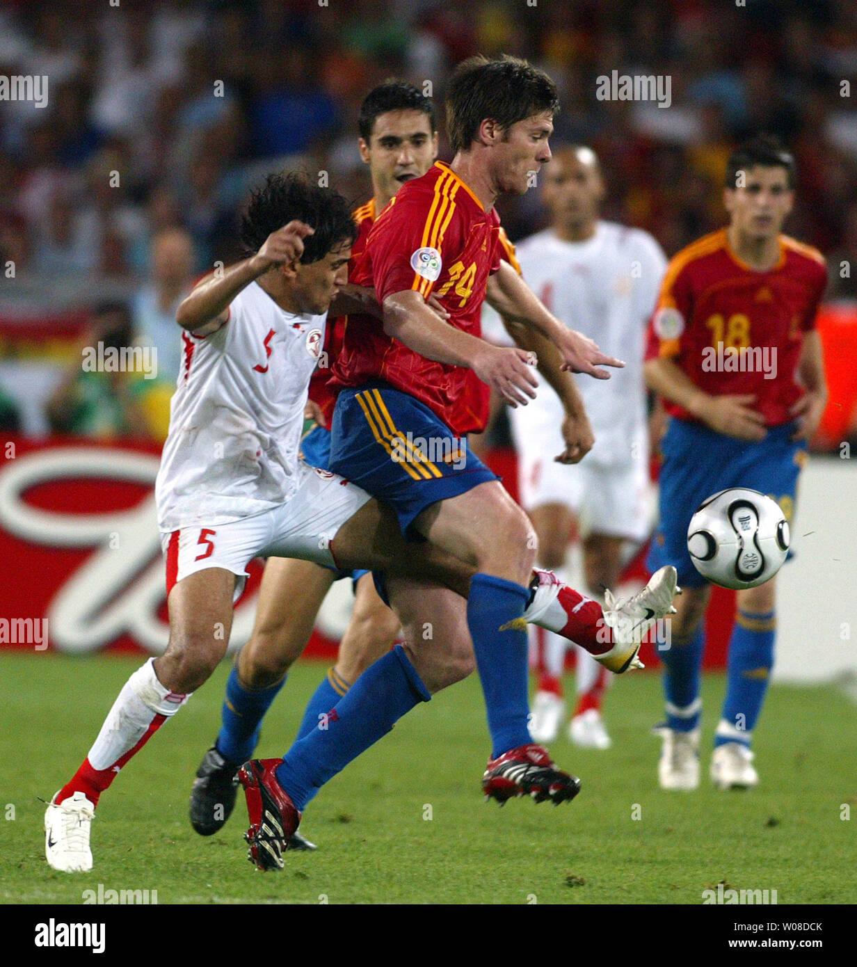 Tunisia's Zied Jaziro (5) kicks at the ball from behind Spain's Xabi Alonso (14) in World Cup soccer action in Stuttgart, Germany on June 19, 2006. Spain defeated Tunisia 3-1.  (UPI Photo/Arthur Thill) Stock Photo