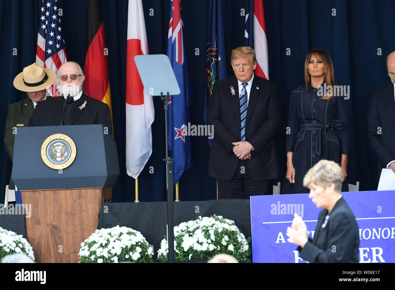 President Donald Trump, First Lady Melania Trump and participants stand for a moment of silence for the victims at a ceremony marking the anniversary of 9/11 at the Flight 93 National Memorial in Shanksville, Pennsylvania on Tuesday, September 11, 2018. It is the 17th anniversary of the crash of United Flight 93 on September 11, 2001.                    Photo by Pat Benic/UPI Stock Photo