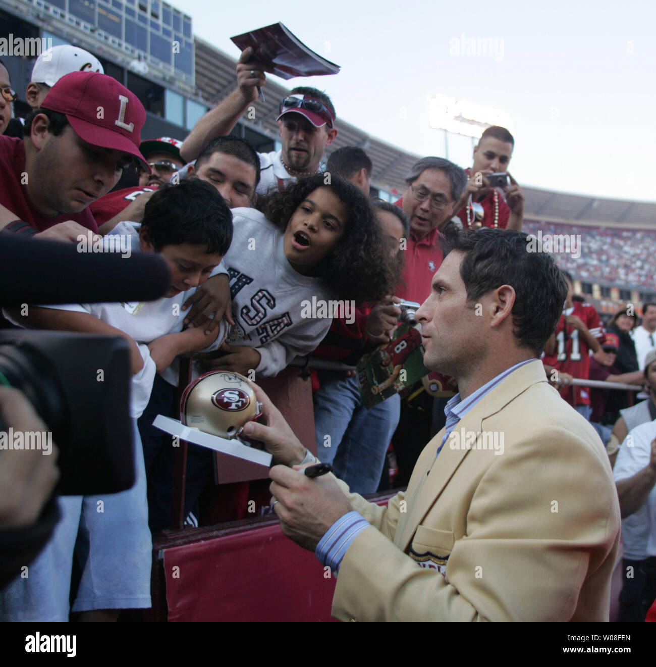 Hall of Fame QB Steve Young signs autographs at Monster Park in San Francisco on November 20, 2005. Young was honored as a new enshrinee to the Hall.  (UPI Photo/Terry Schmitt) Stock Photo
