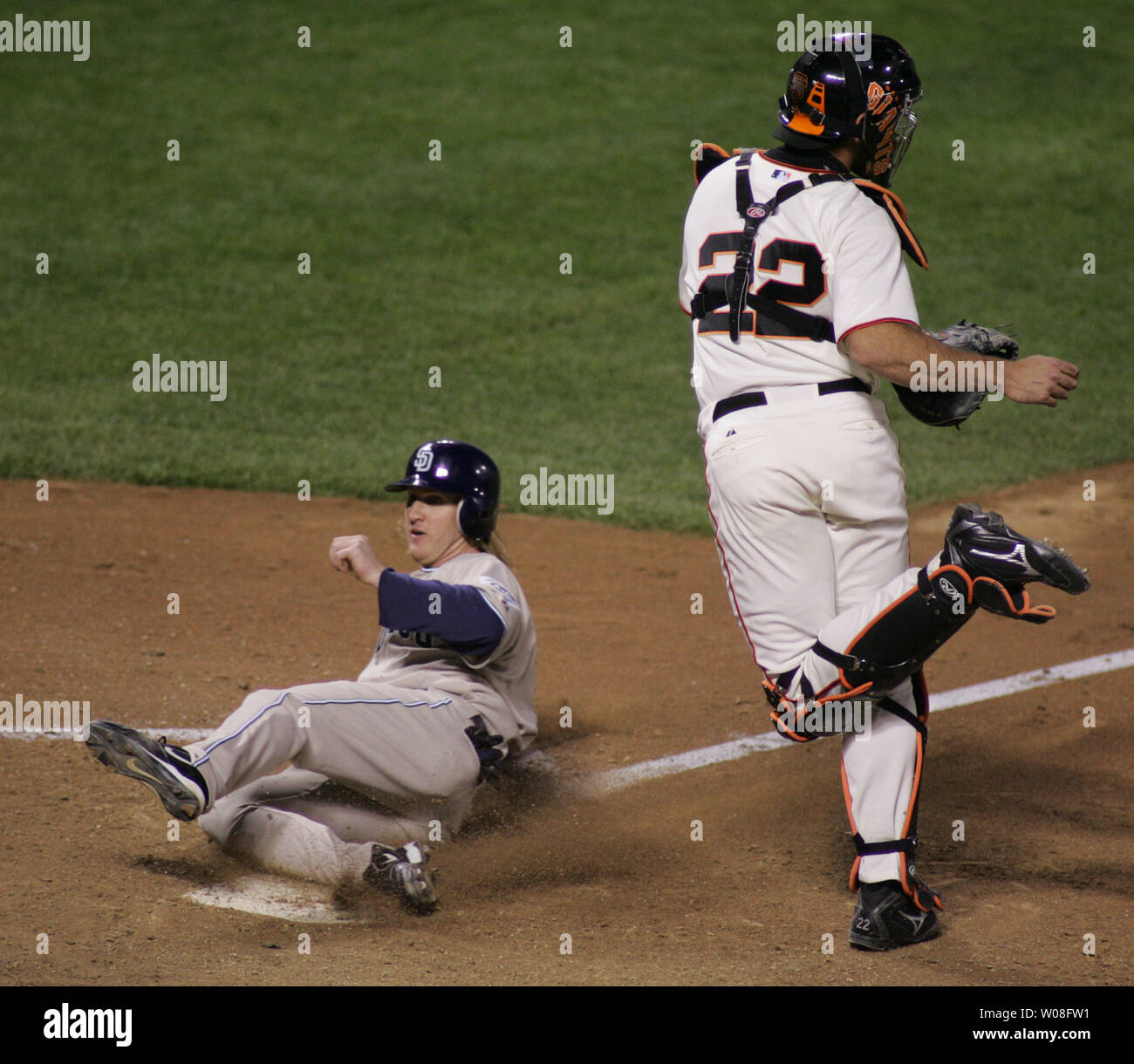 San Francisco Giants catcher Mike Matheny (22) pivots away from the plate as San Diego Padres Khalil Greene slides across in the third inning at AT&T Park in San Francisco on May 1, 2006.  Greene scored after Giants 3B Pedro Feliz  committed an error on a grounder by Jake Peavy.  (UPI Photo/Terry Schmitt) Stock Photo