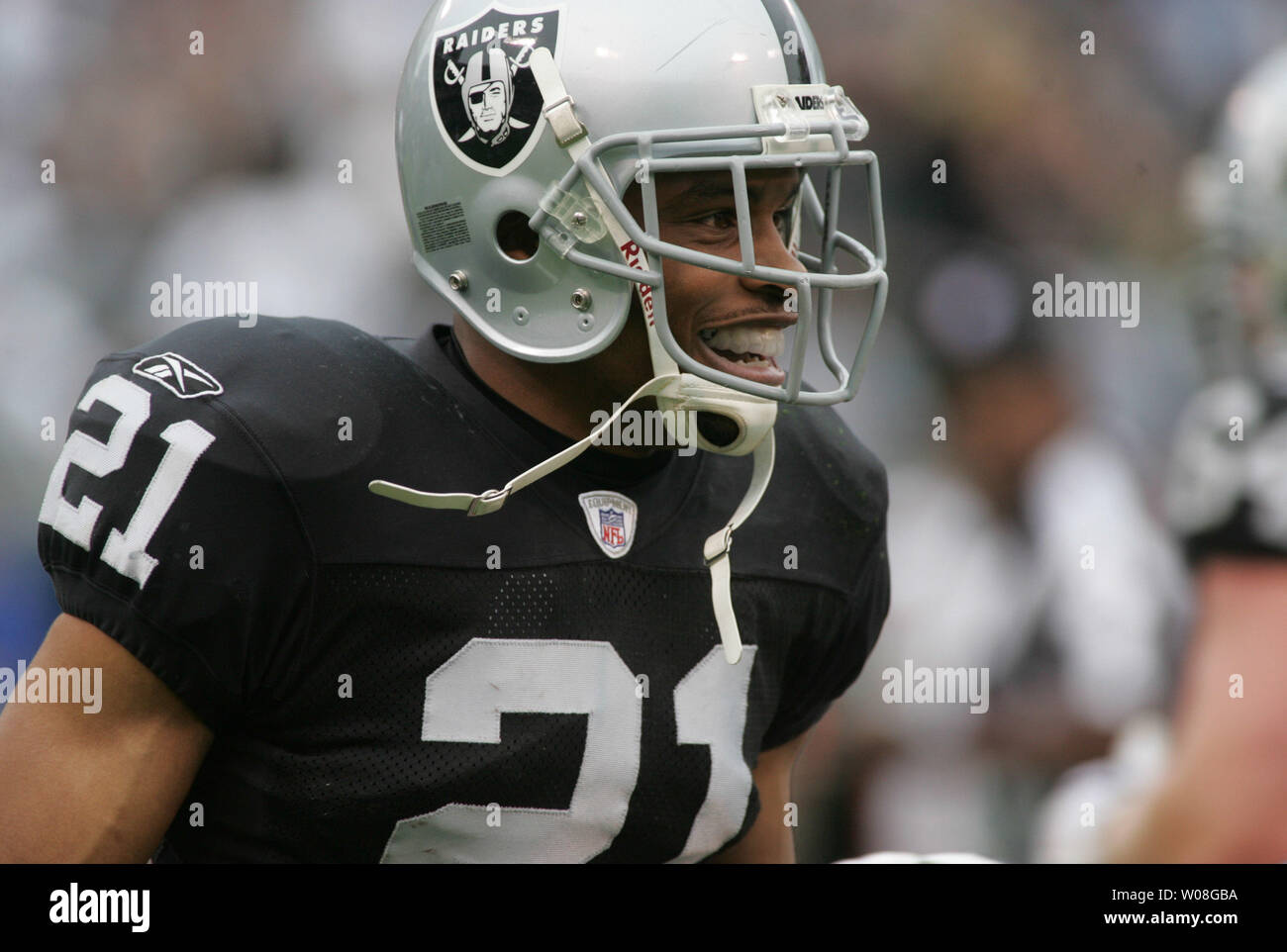 Oakland Raiders Nnamdi Asomugha (21) is all smile after intercepting a pass  by Cleveland Browns QB Charlie Frye intended for Braylon Edwards in the  first quarter at McAfee Coliseum in Oakland, California