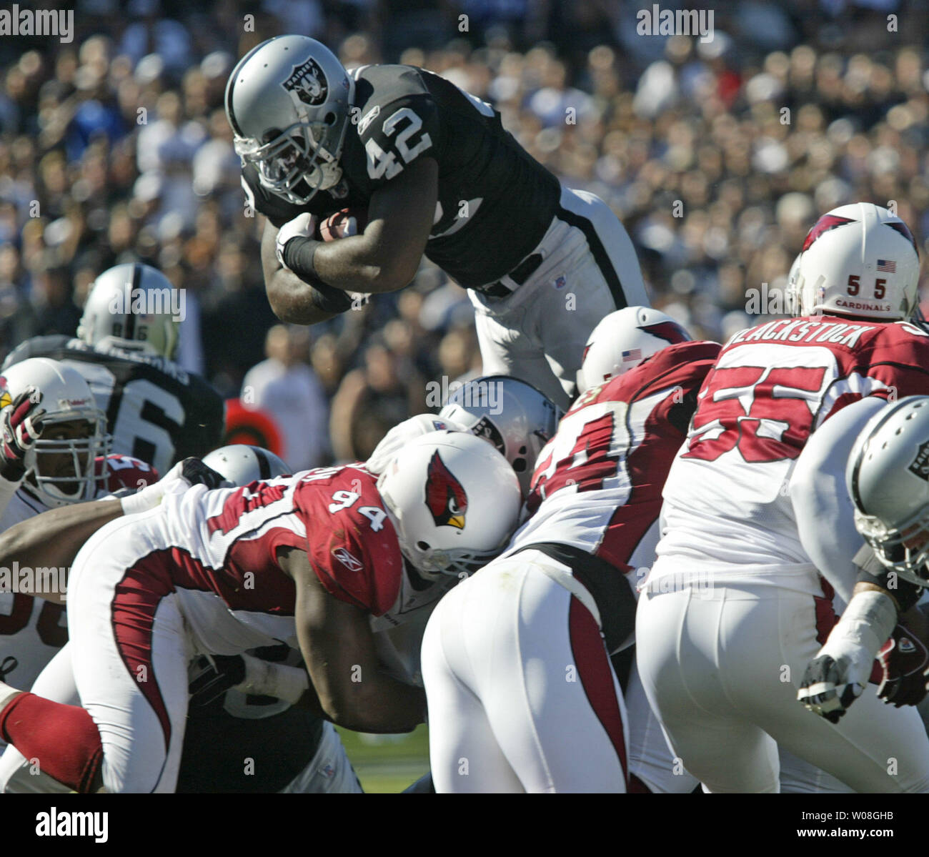 Oakland Raiders ReShard Lee (42) dives over the Arizona Cardinals defense  for a one yard TD