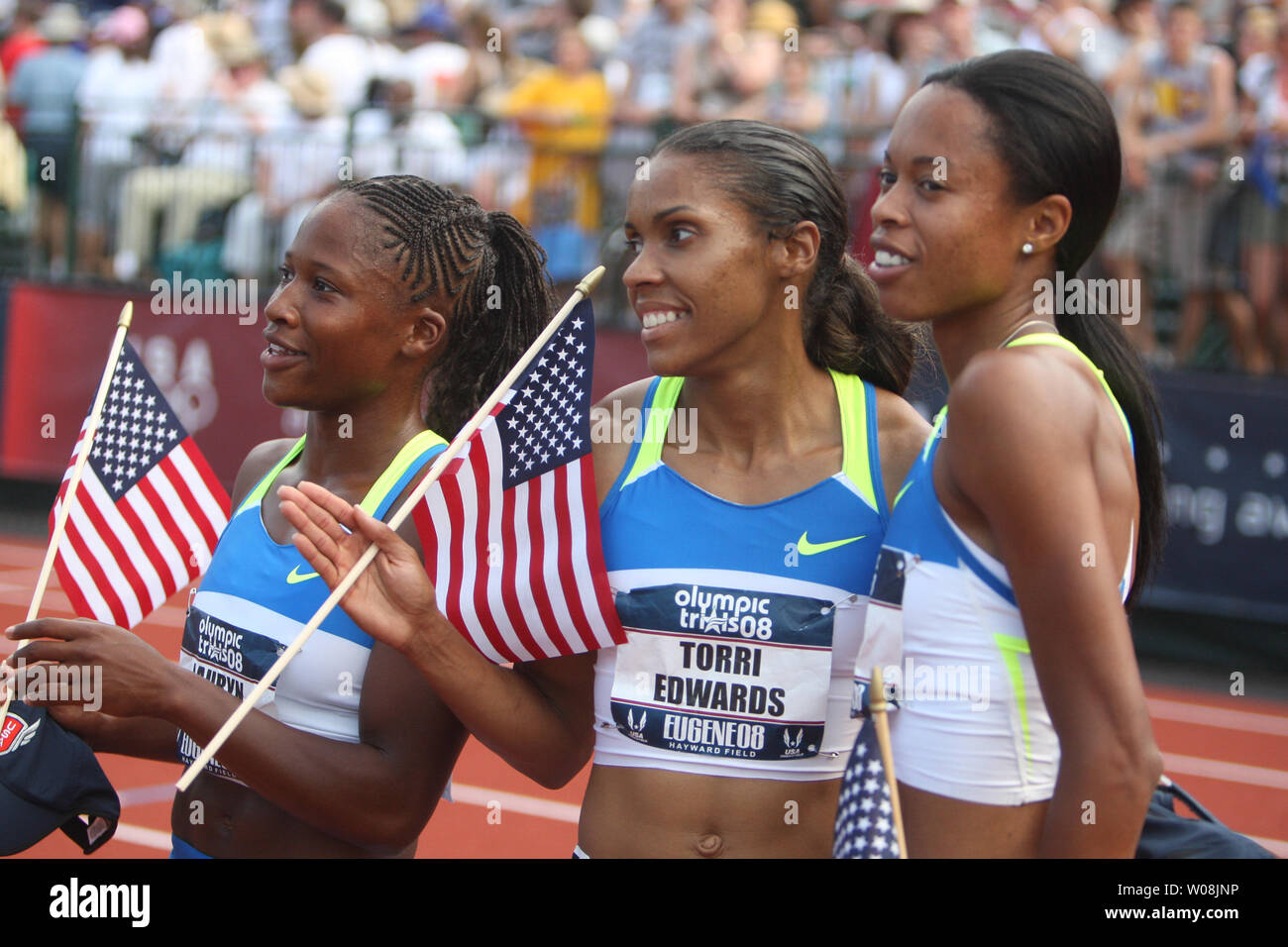 U.S. sprinter Muna Lee (R) makes her move past Torri Edwards (C) and Lauryn Williams wait to be interviewed after the finals of the 100 meters at the USA Track and Field trials in Eugene Oregon on June 28, 2008. Lee won the race, but all three qualified for the U.S. Olympic team.    (UPI Photo/Terry Schmitt) Stock Photo