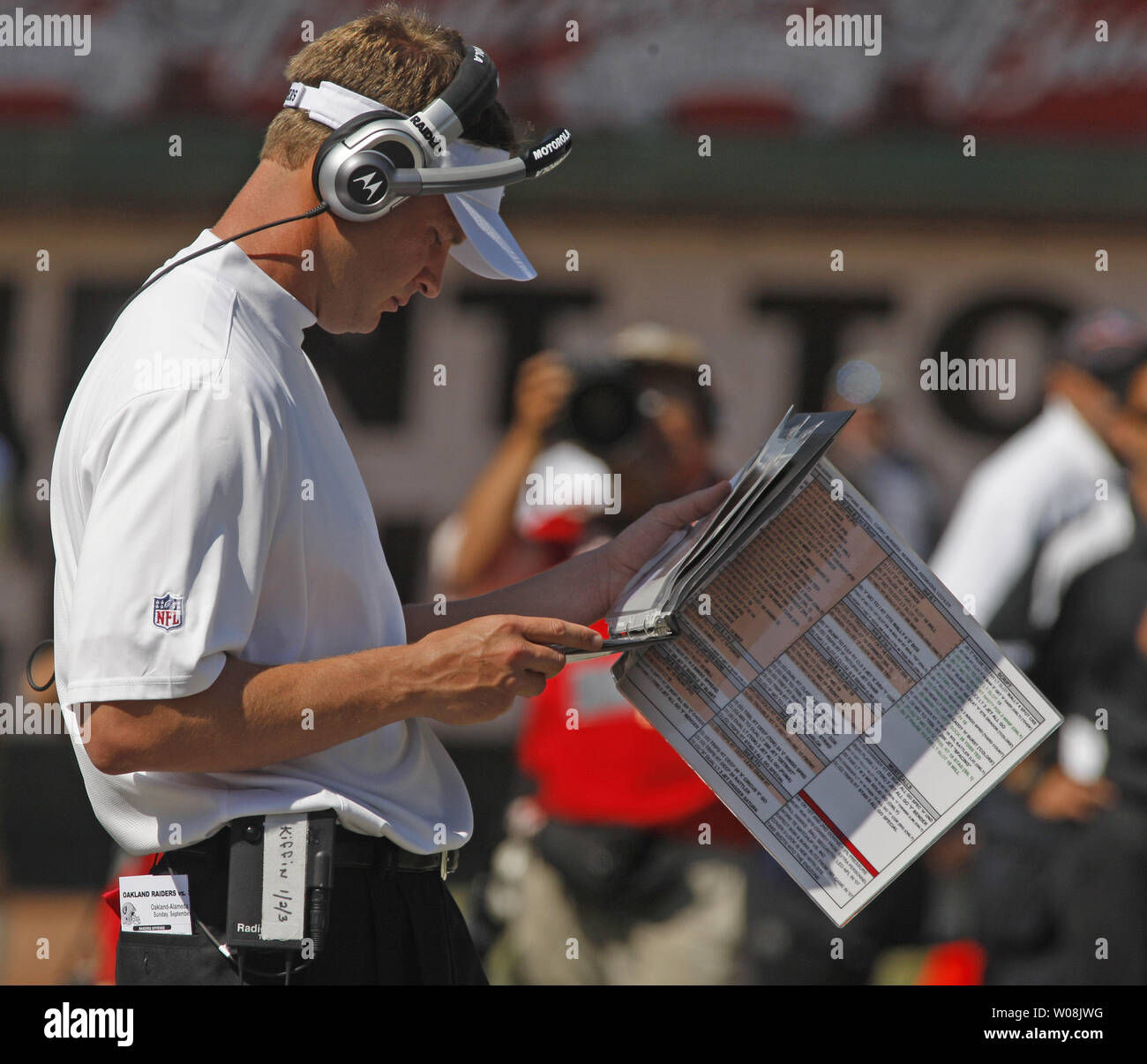 Oakland Raiders head coach Lane Kiffin studies formation photographs during play against the San Diego Chargers at the Coliseum in Oakland, California on September 28, 2008. The Chargers defeated the Raiders 28-18.  (UPI Photo/Terry Schmitt) Stock Photo