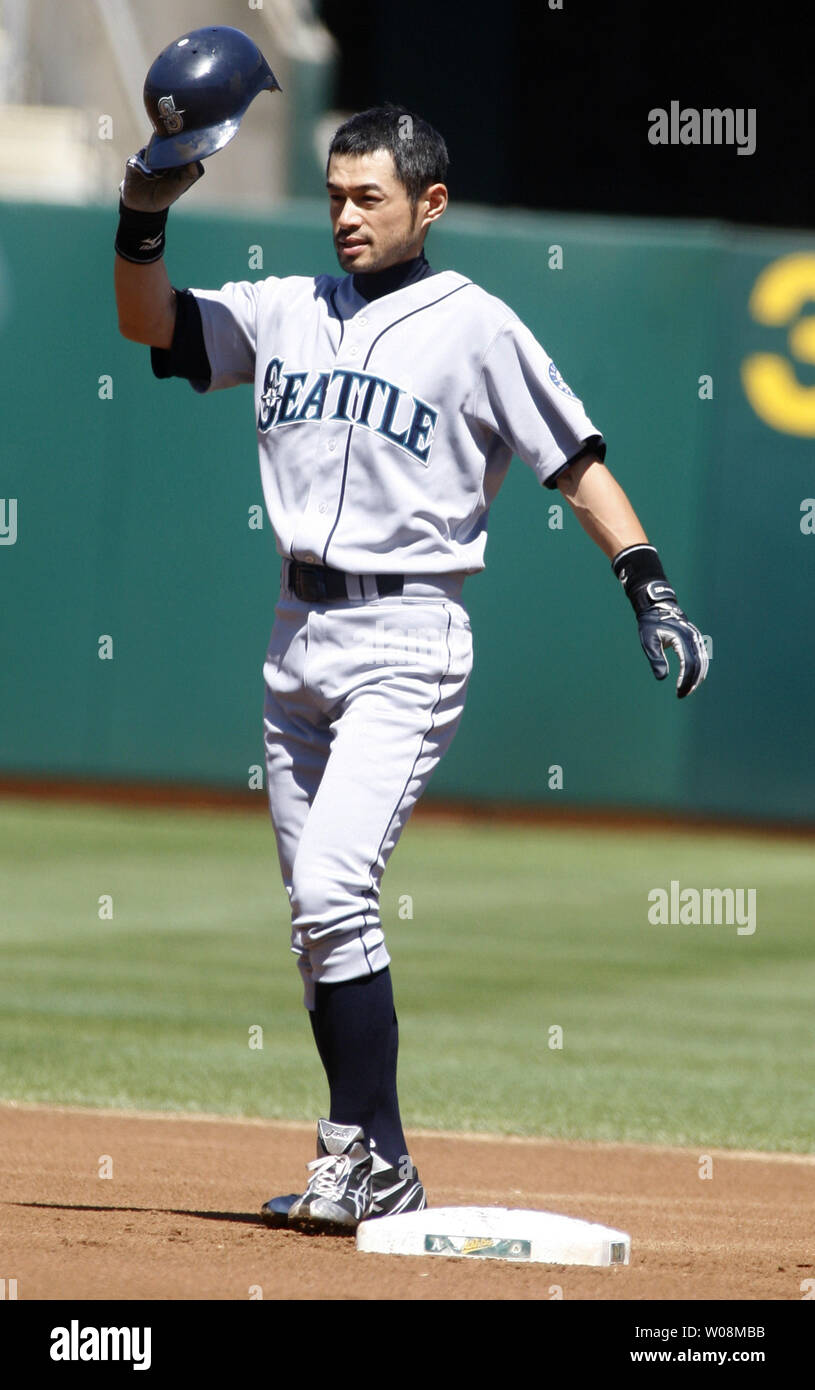 Seattle Mariners' Ichiro Suzuki adjusts his helmet after hitting a