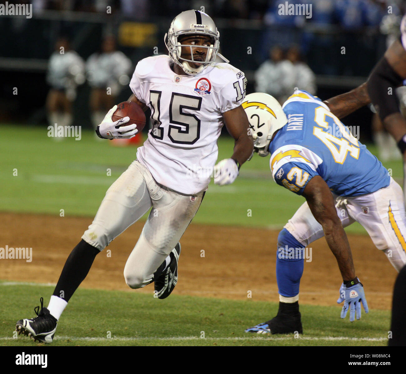 Oakland Raiders WR Johnnie Lee Higgins (15) runs past San Diego Chargers  Clinton Hart on a reverse in the third quarter at the Oakland Coliseum in  Oakland, California on September 14, 2009.