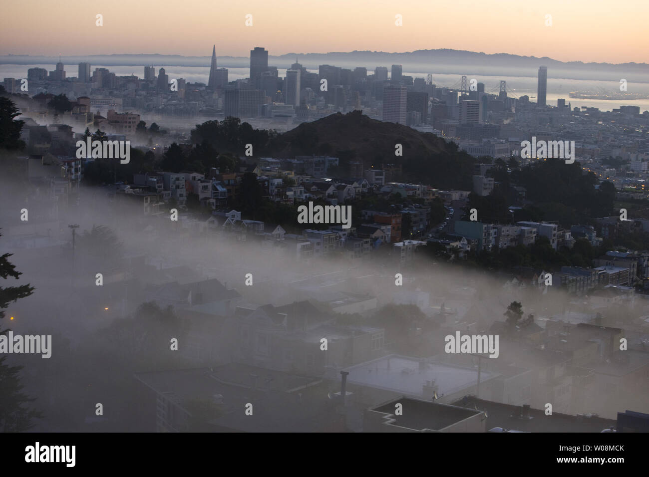 A finger of fog begins to disappear at dawn in San Francisco on September 22, 2009. California is expecting triple digit temperatures.   UPI/Terry Schmitt Stock Photo