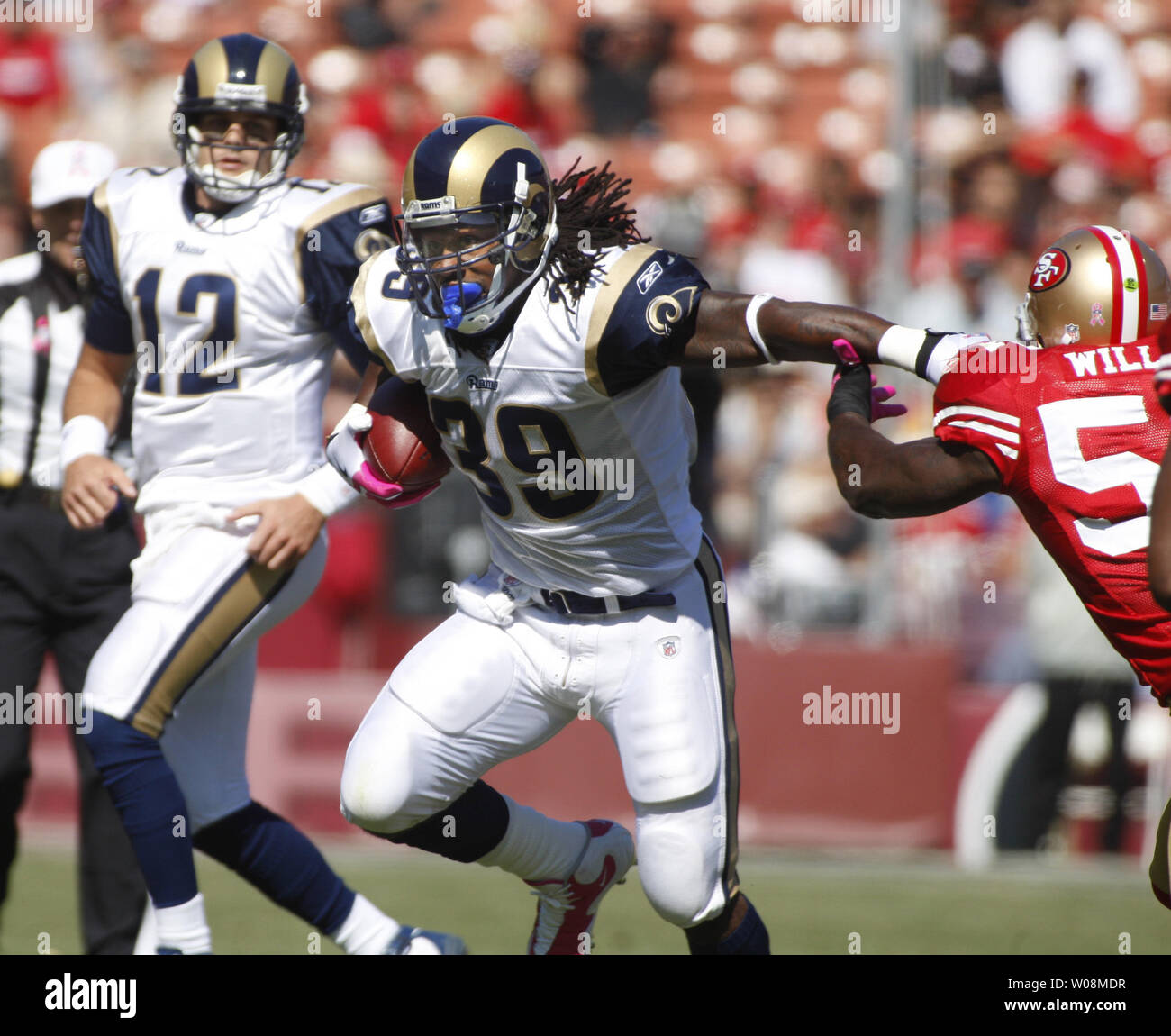 St. Louis Rams RB Steven Jackson (39) throws a straight arm at San Francisco 49ers Patrick Willis (R) as QB Kyle Boller (12) watches at Candlestick Park in San Francisco on October 4, 2009. The 49ers defeated the Rams 35-0.    UPI/Terry Schmitt Stock Photo