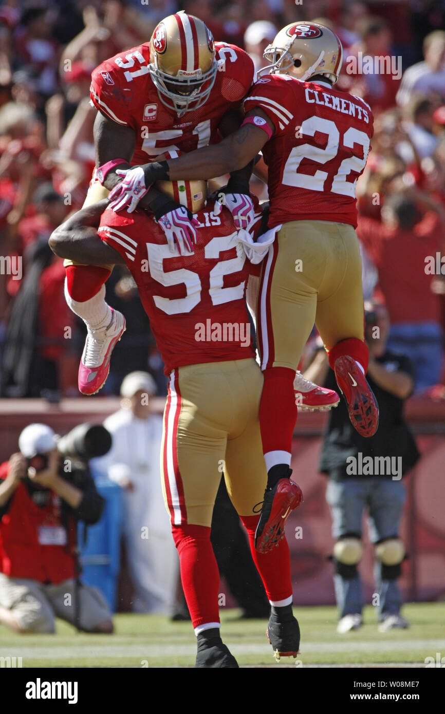 49ers linebacker Patrick Willis (52) is mobbed by Takeo Spikes (51) and Nate Clements (22) after returning an intercepted pass from St. Louis Rams QB Kyle Boller for a touchdown, in the third quarter at Candlestick Park in San Francisco on October 4, 2009. The 49ers defeated the Rams 35-0.    UPI/Terry Schmitt Stock Photo