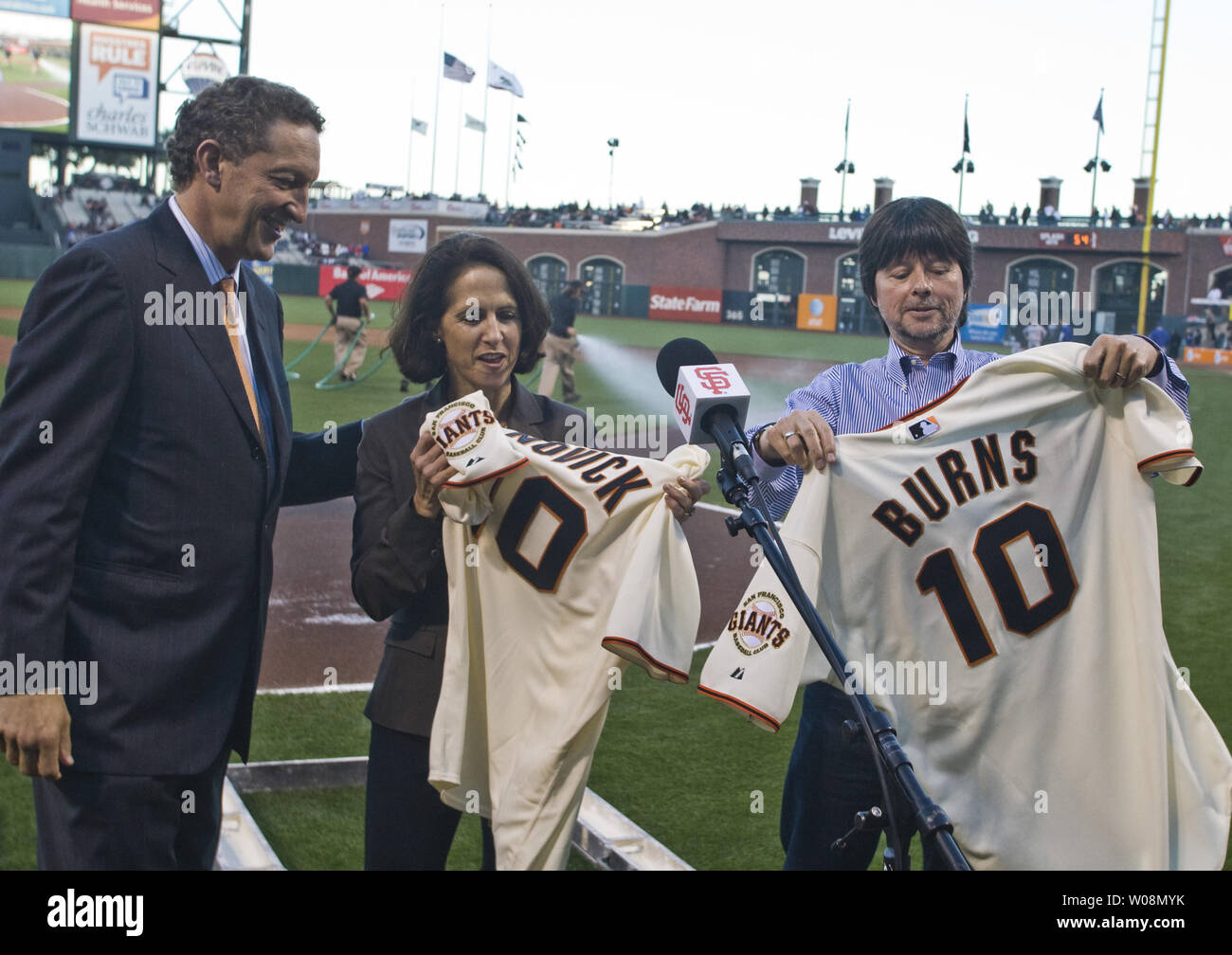 San Francisco Giants President and CEO Larry Baer (L) presents Giants shirts to filmmakers Lynn Novick (C) and Ken Burns at AT&T Park in San Francisco on September 14, 2010.  Novick and Burns were in the city to promote their new documentary 'The Tenth Inning'.   UPI/Terry Schmitt Stock Photo