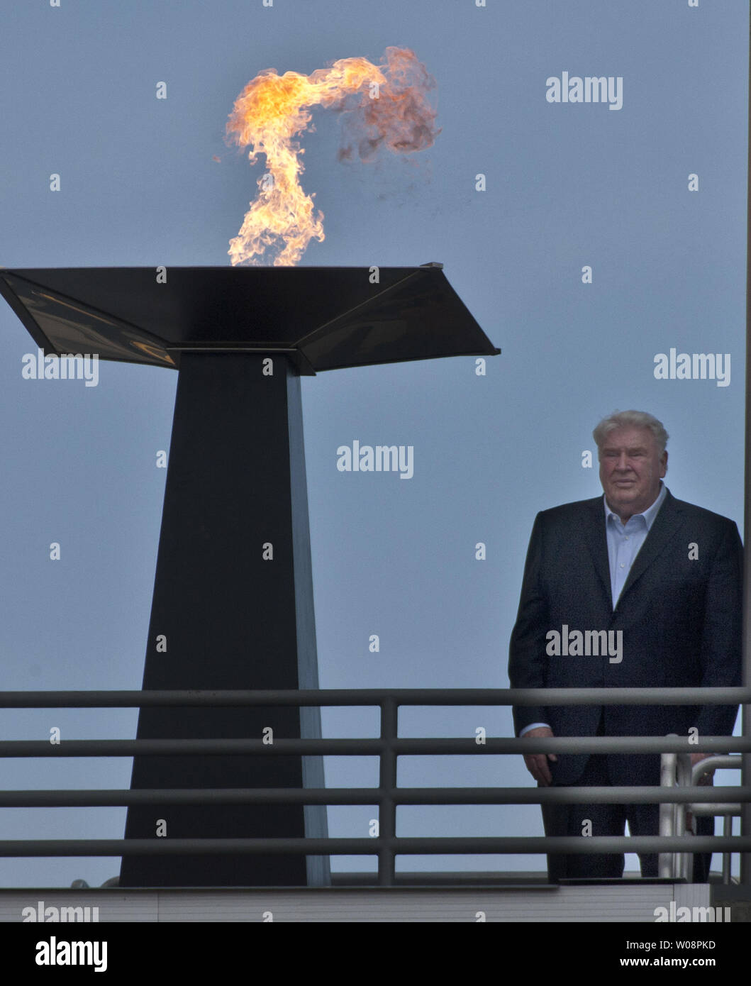 Former Oakland Raiders  coach John Madden stands beside a flame lit in tribute to the late Al Davis, the Raiders' owner who died 10/8, at a halftime ceremony at the Coliseum during a game against the Cleveland Browns on October 16, 2011 in Oakland, California.     UPI/Terry Schmitt Stock Photo
