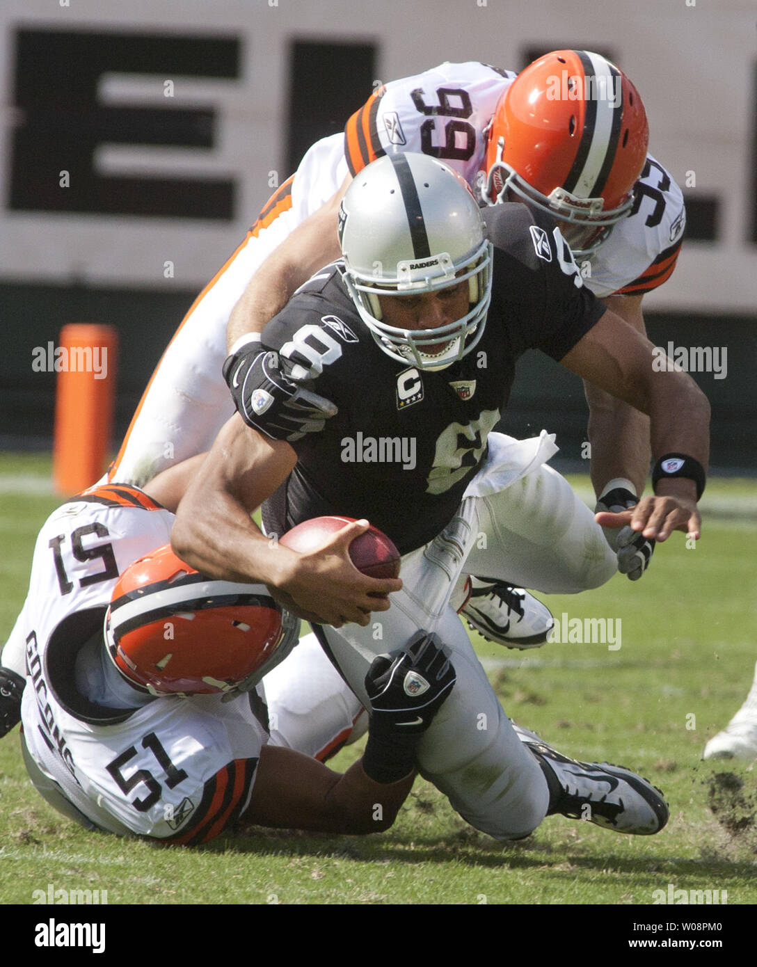 Oakland Raiders QB Jason Campbell is tackled by Cleveland Browns Chris Gocong (51) and Scott Fujita (99) in a play that resulted in Campbell breaking his collarbone at the Coliseum in Oakland, California on October 16, 2011. The Raiders defeated the Browns 24-17.     UPI/Terry Schmitt Stock Photo