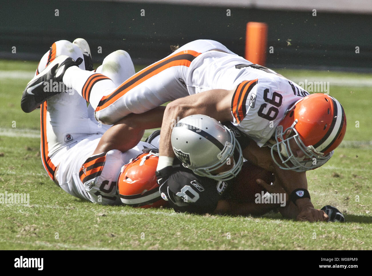 Oakland Raiders QB Jason Campbell (8) is tackled by Cleveland Browns Chris Gocong (51) and Scott Fujita (99) in a play that resulted in Campbell breaking his collarbone at the Coliseum in Oakland, California on October 16, 2011. The Raiders defeated the Browns 24-17.     UPI/Terry Schmitt Stock Photo