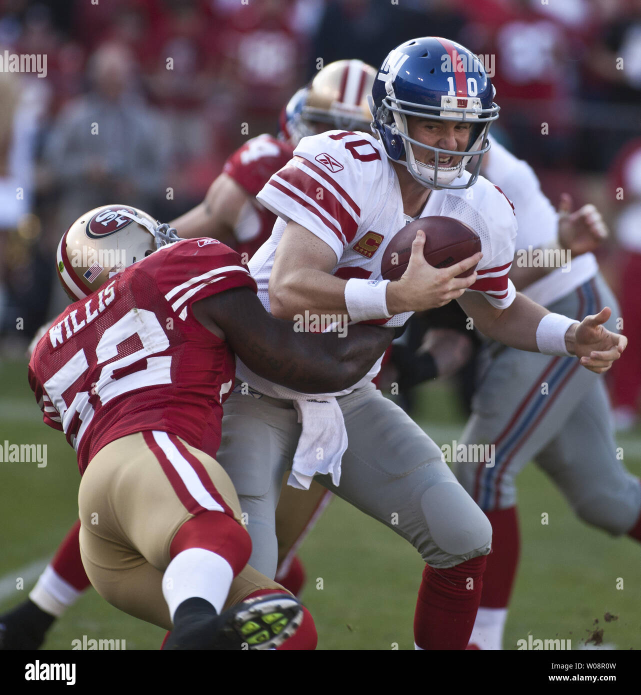 New York Giants QB Eli Manning (10) is sacked by San Francisco 49ers Patrick Willis at Candlestick Park in San Francisco on November 13, 2011.  The 49ers defeated the Giants 27-20.     UPI/Terry Schmitt Stock Photo