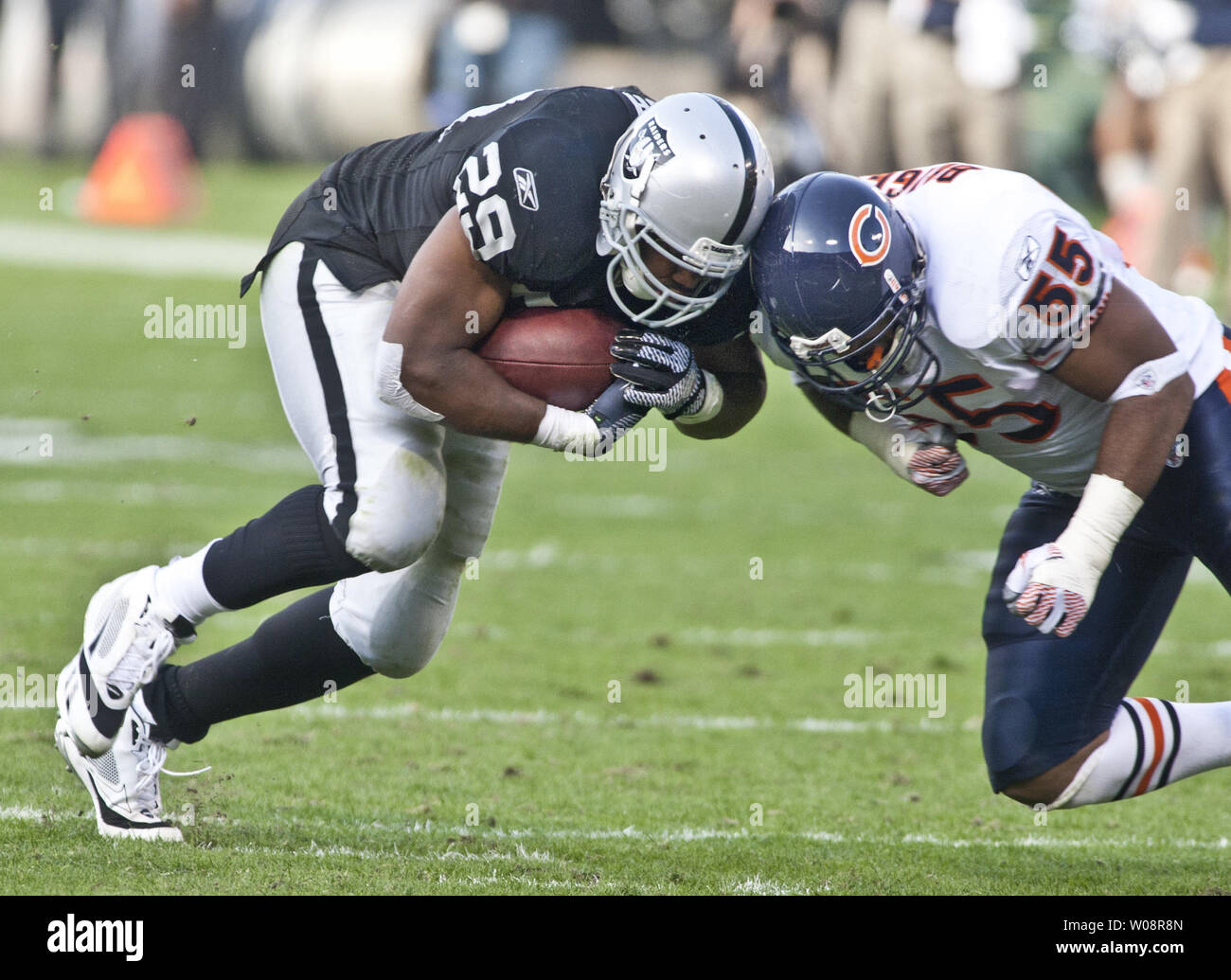 Oakland Raiders Michael Bush (29) goes helmet to helmet with Chicago Bears  Lance Briggs (55) at