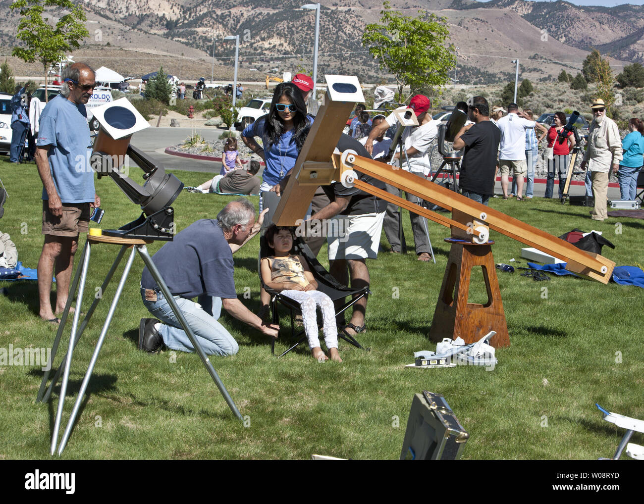 People line up their equipment during the viewing of an annular solar