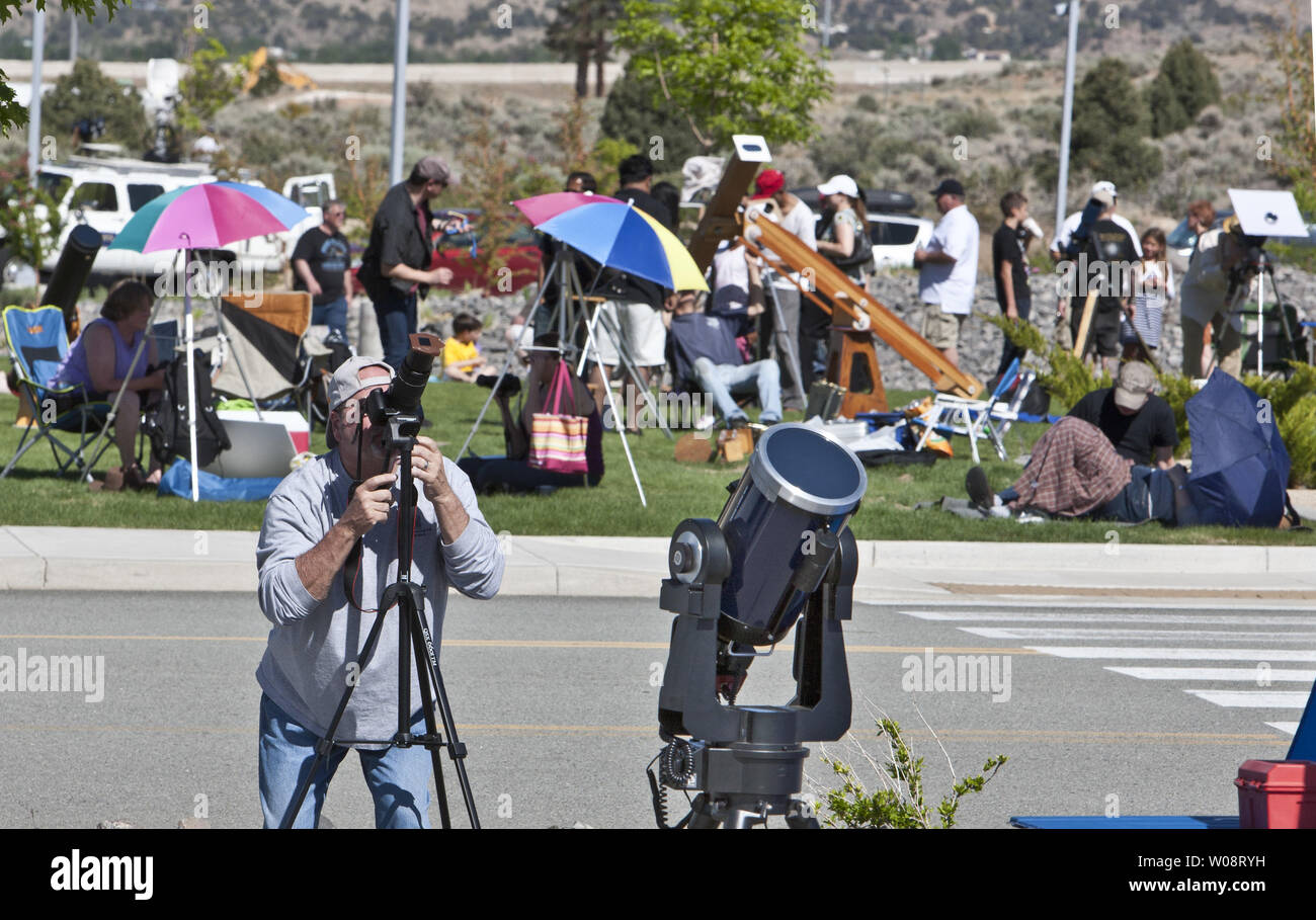 People line up their equipment during the viewing of an annular solar