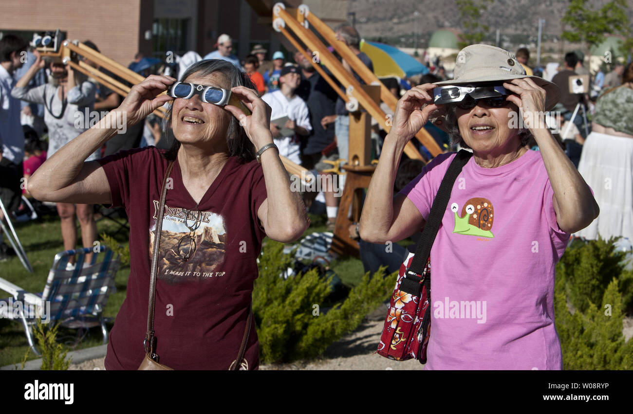 Two women use mylar glasses for viewing of an annular solar eclipse