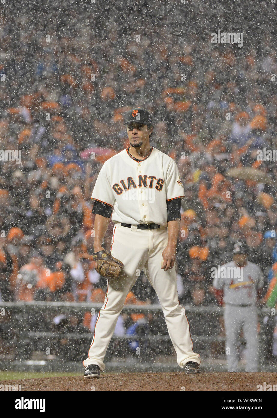 San Francisco Giants reliever Javier Lopez stands in a downpour while  pitching against the St. Louis Cardinals during game seven of the National  League Championship Series at AT&T Park in San Francisco