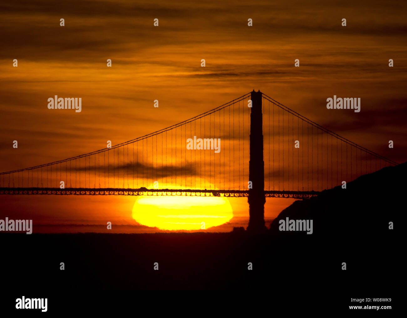 The sun sets behind the north tower of the Golden Gate Bridge on November 13, 2012 as seen from Berkeley, California.    UPI/Terry Schmitt Stock Photo
