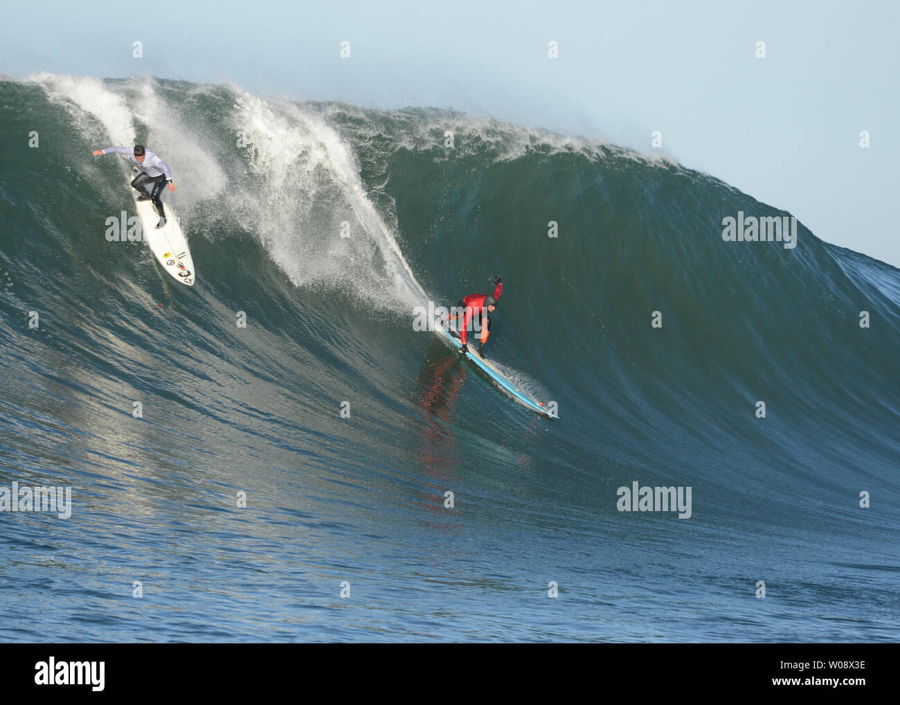 Peter Mel red and Dave Wassel take off on a wave during the