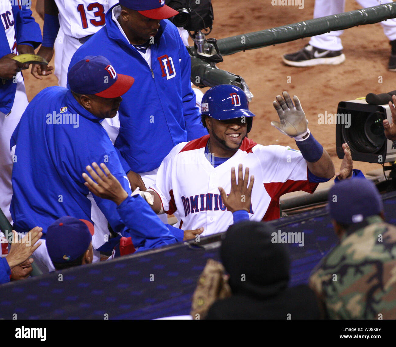 Dominican Republic's Carlos Santana is congratulated at the dugout after scoring against Netherlands in the fifth inning of the semi finals of the World Baseball Classic at AT&T Park in San Francisco on March 18, 2013. Dominican Republic defeated Netherlands 4-1.   UPI/Bruce Gordon Stock Photo