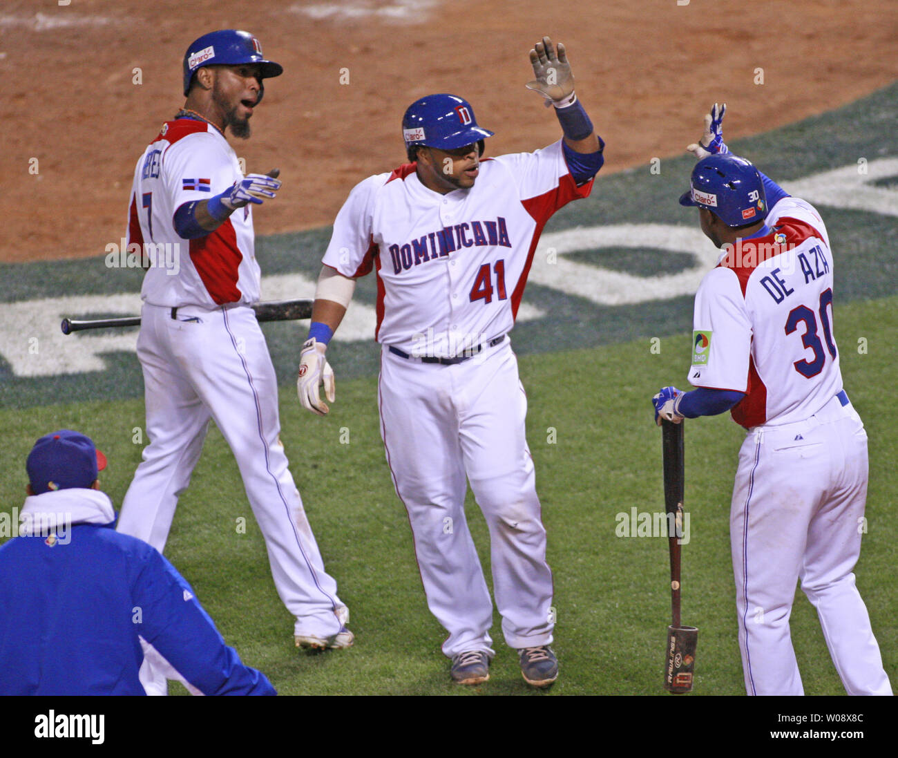 Dominican Republic's Carlos Santana (41) is congratulated at the dugout after scoring against Netherlands in the fifth inning of the semi finals of the World Baseball Classic at AT&T Park in San Francisco on March 18, 2013. Dominican Republic defeated Netherlands 4-1.   UPI/Bruce Gordon Stock Photo