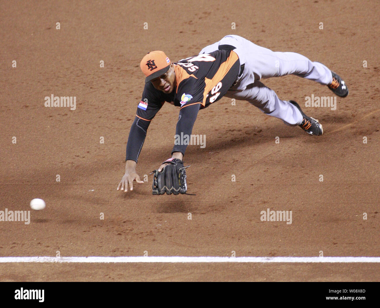 3B Jonathon Schoop of Netherlands dives and misses a double by Dominican Republic's Carlos Santana in the fifth inning of the semi finals of the World Baseball Classic at AT&T Park in San Francisco on March 18, 2013. Dominican Republic defeated Netherlands 4-1.   UPI/Bruce Gordon Stock Photo