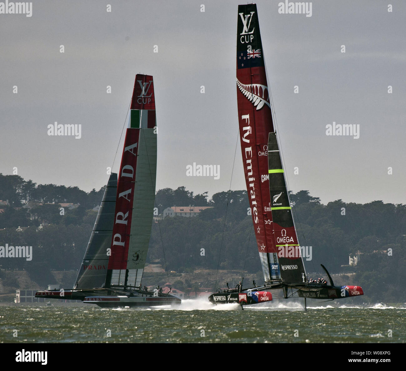 Emirates New Zealand (R) flies in front of Italy's Luna Rossa Challenge in race four of the finals of the Louis Vuitton Cup in San Francisco Bay on August 21, 2013. The winner of the best of 13 races will face Oracle USA in the America's Cup. The Kiwis won races four and five.     UPI/Terry Schmitt Stock Photo