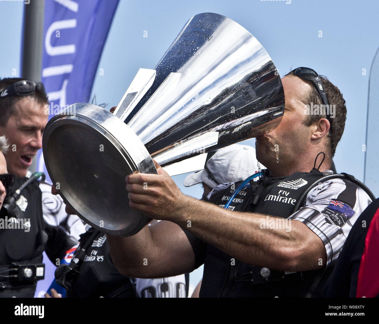 A crew member of Emirates New Zealand drinks champagne from the Louis Vuitton Cup after defeating Italy's Luna Rossa Challenge in San Francisco on August 25, 2013.  The Kiwis won the best of 13 series 7-1 to win the cup and move on to race Oracle Team USA in the America's Cup.     UPI/Terry Schmitt Stock Photo