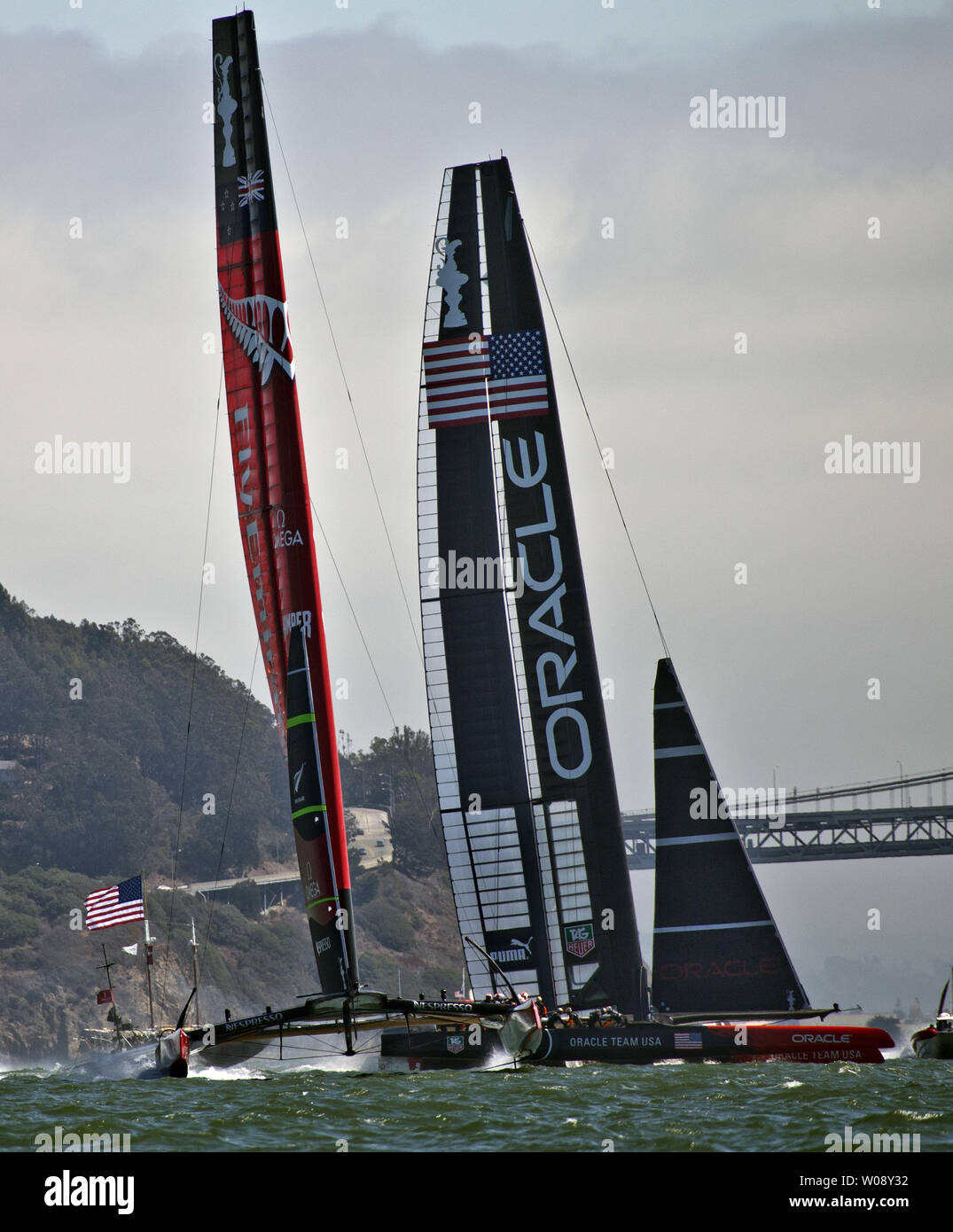 Emirates New Zealand (L) and Oracle Team USA sail upwind in race eight of the America's Cup series on San Francisco Bay on September 14, 2013. The USA won the race as the Kiwis nearly capsized near the windward mark.   UPI/Terry Schmitt Stock Photo