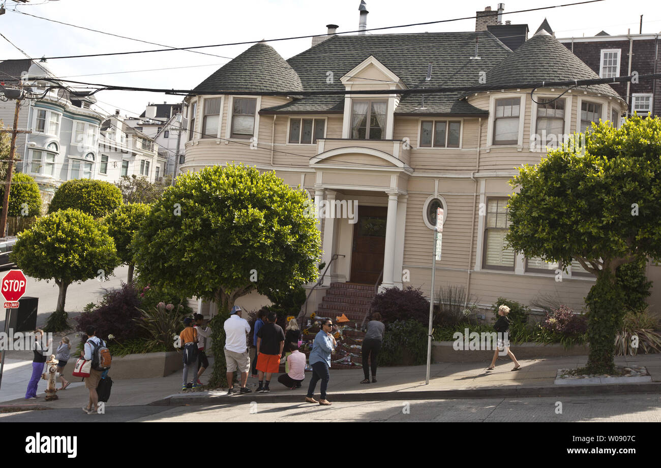 People gather at a makeshift shrine to Robin Williams at the San Francisco Victorian house used in the 1993 movie 'Mrs. Doubtfire' on August 12, 2014. Williams died of asphyxia after hanging himself August 11. He was 63.     UPI/Terry Schmitt Stock Photo