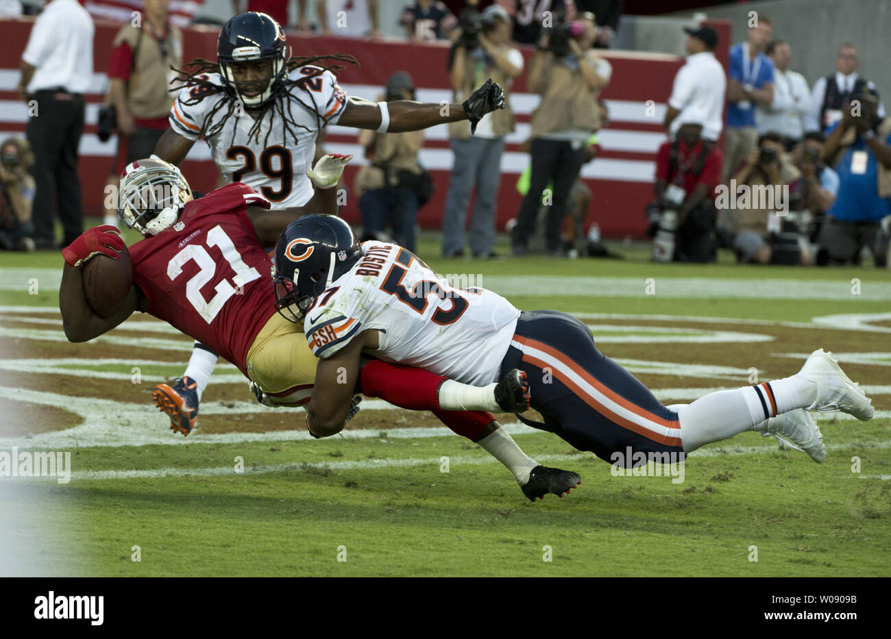 San Francisco 49ers RB Frank Gore holds on to the shirt tail of FB Bruce  Miller (49) on a third quarter run against the Houston Texans at  Candlestick Park in San Francisco