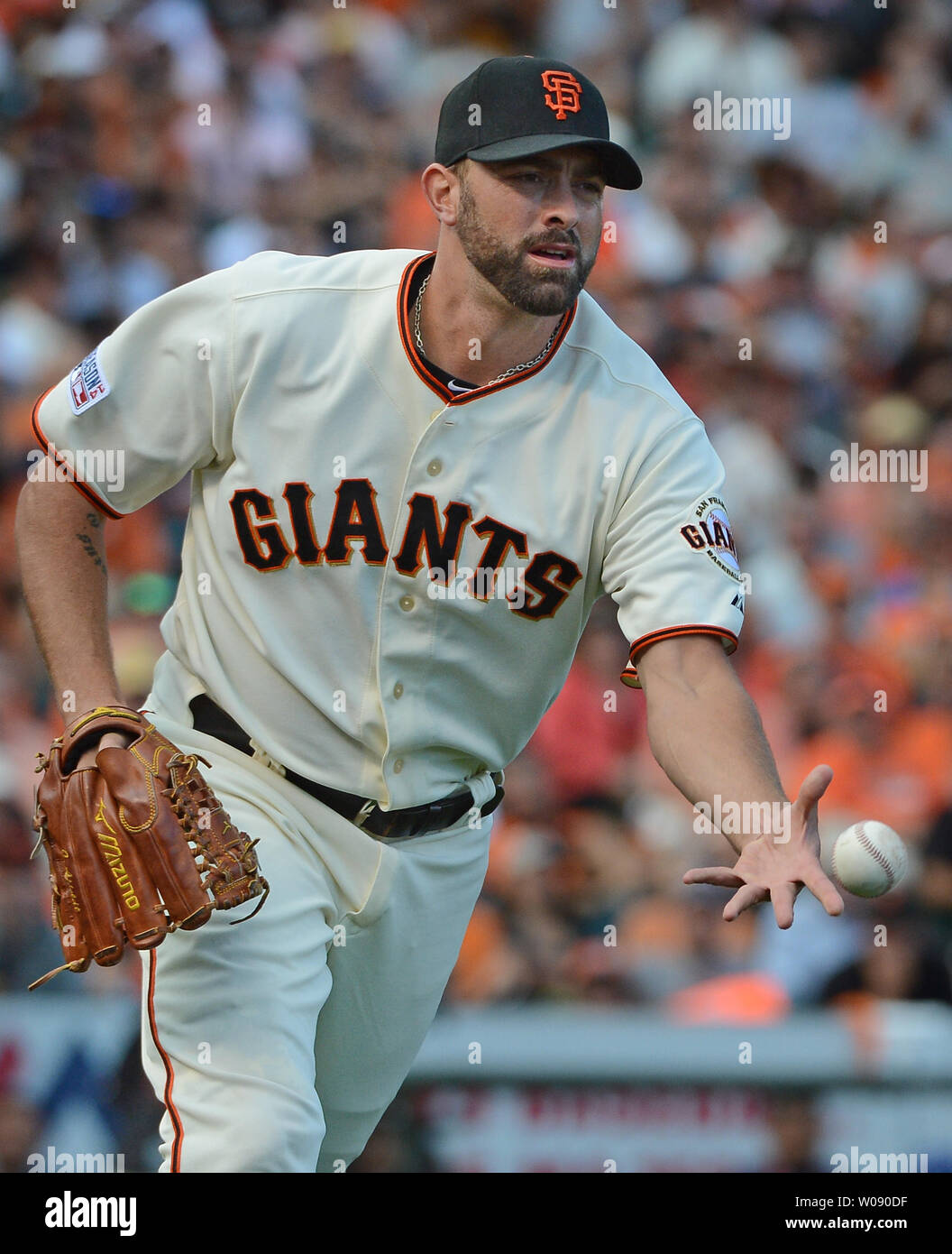 San Francisco Giants reliever Jeremy Affeldt  lobs the ball to first to get Washington Nationals Jordan Zimmerman in the ninth inning of game 3 of the National League Division Series at AT&T Park in San Francisco on October 6, 2014. UPI/Terry Schmitt Stock Photo
