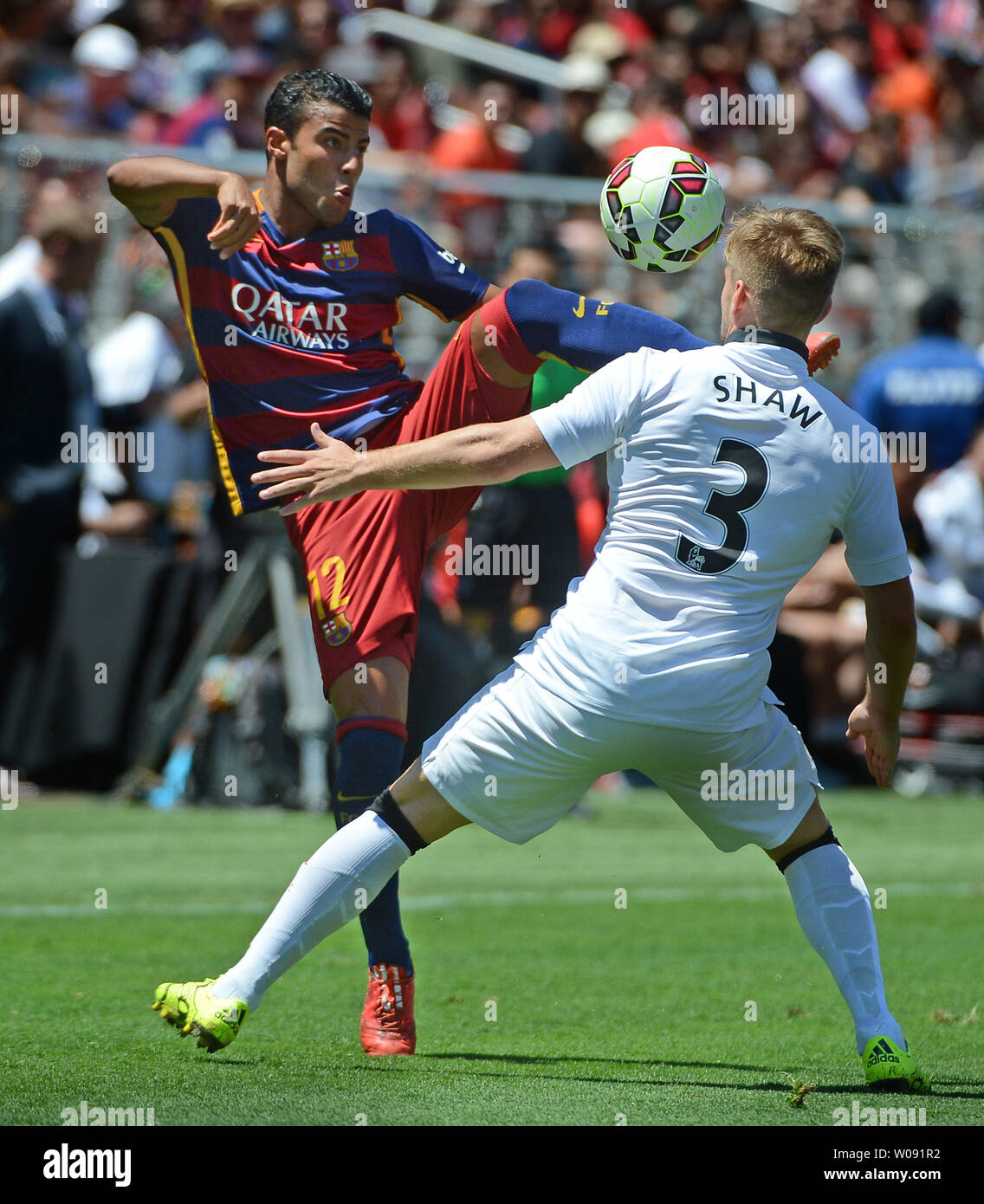 FC Barcelona's Rafinha (12) controls the ball in front of Manchester United's Luke Shaw in the second half in the 2015 International Champions Cup North America at Levi's Stadium in Santa Clara, California on July 25, 2015. Manchester defeated Barcelona 3-1.  Photo by Terry Schmitt/UPI Stock Photo