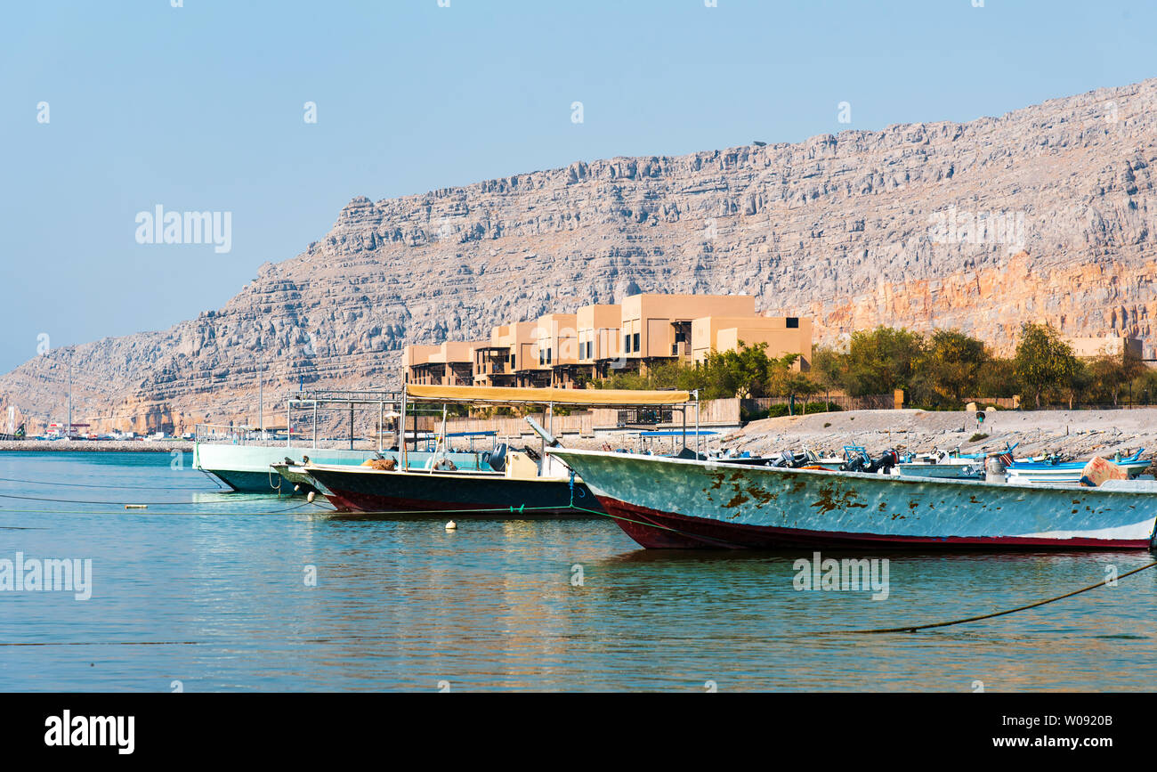 Khasab city creek with boats and desert rock scenery in Oman Stock Photo