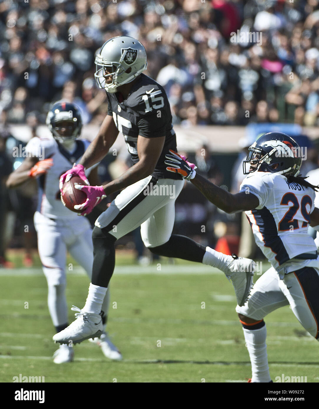 Oakland Raiders WR Michael Crabtree (15) catches a Derek Carr pass for 25 yards against the Denver Broncos Bradley Roby (R) in the first quarter at O.co Coliseum in Oakland, California on October 11, 2015. The Broncos defeated the Raiders 16-10.  Photo by Terry Schmitt/UPI Stock Photo