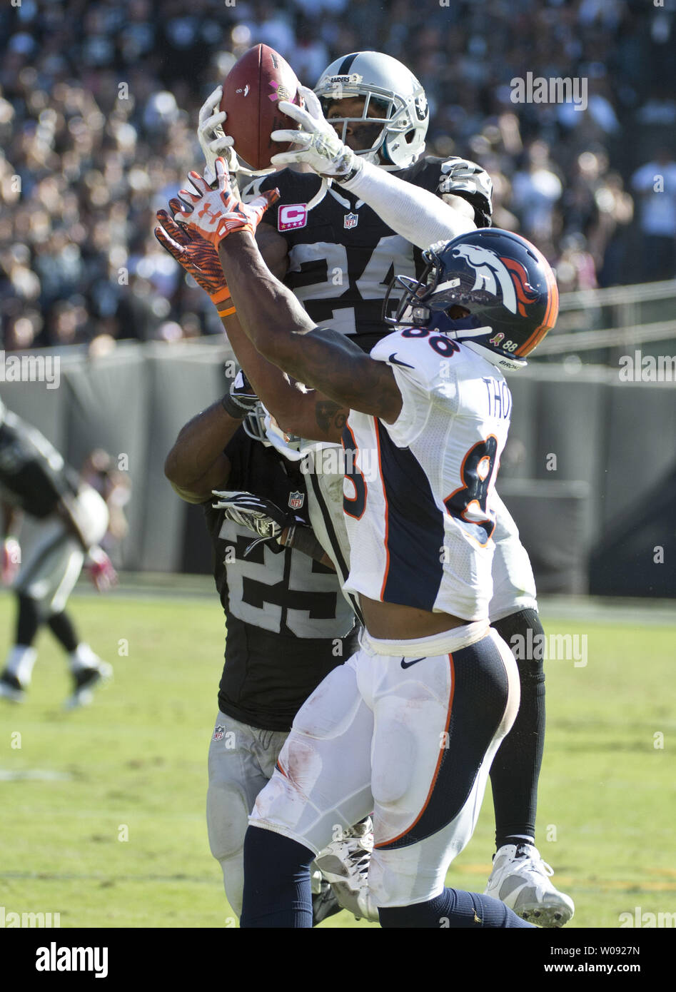 Oakland Raiders Charles Woodson (24) goes high to intercept a Denver Broncos Peyton Manning pass intended for Demaryius Thomas in the third quarter at O.co Coliseum in Oakland, California on October 11, 2015. The Broncos defeated the Raiders 16-10.  Photo by Terry Schmitt/UPI Stock Photo