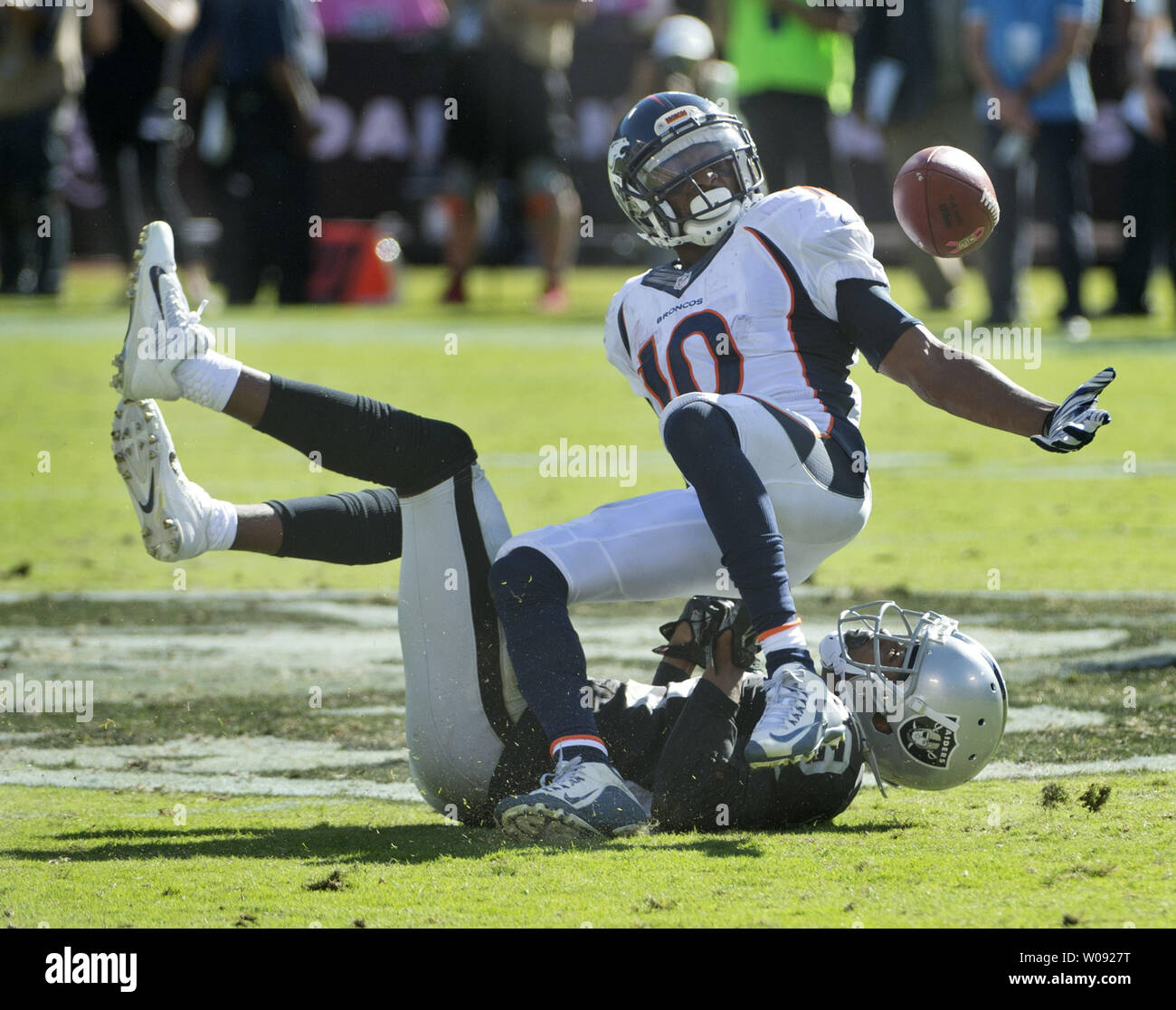 Denver Broncos Emmanuel Sanders (R) tries to hold on to a Peyton Manning pass as he is hit by Oakland Raiders David Amerson (29) in the third quarter at O.co Coliseum in Oakland, California on October 11, 2015. The Broncos defeated the Raiders 16-10.  Photo by Terry Schmitt/UPI Stock Photo