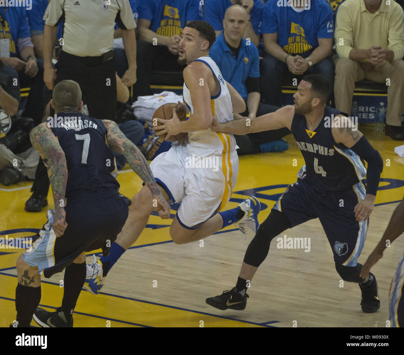 Golden State Warriors Klay Thompson drives to the basket between Memphis Grizzles Chris Anderson (7) and Jordan Farmer (4) in the first period at Oracle Arena in Oakland, California on April 13, 2016. The Warriors defeated the Grizzles to set a season record of 73 wins.    Photo by Terry Schmitt/UPI Stock Photo