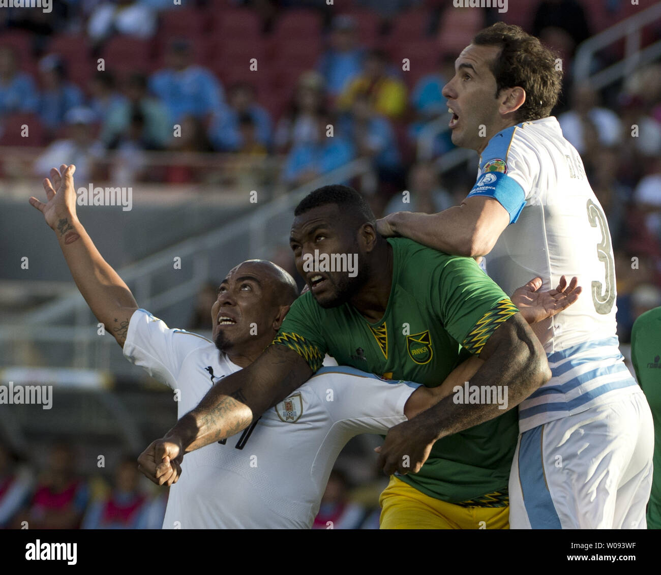 Jamaica's Westley Morgan (C) gets squeezed between Uruguay's Raul Arevlo  Rios (L) and Diego Godin on a corner kick in the first half at COPA America  Centenario at Levi's Stadium in Santa