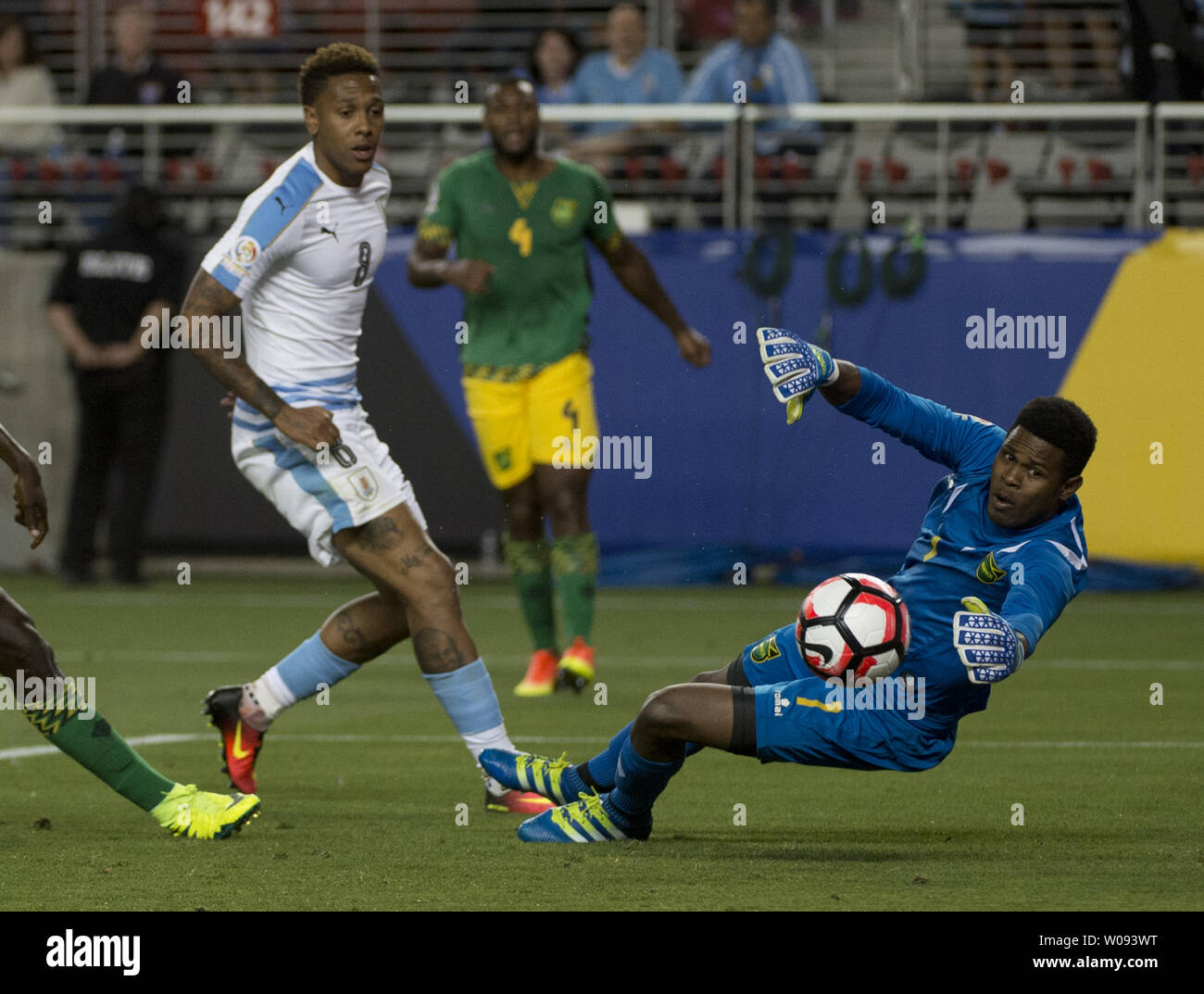 Jamaica's goalie Andre Blake (R) dives for a ball off the hand of teammate Je-Vaughn Watson (unseen) as Uruguay's Abel Hernandez (8) looks on in the second half at COPA America Centenario at Levi's Stadium in Santa Clara, California on June 13,  2016.  Jamaica was credited with an own goal as Uruguay won 3-0.    Photo by Terry Schmitt/UPI Stock Photo