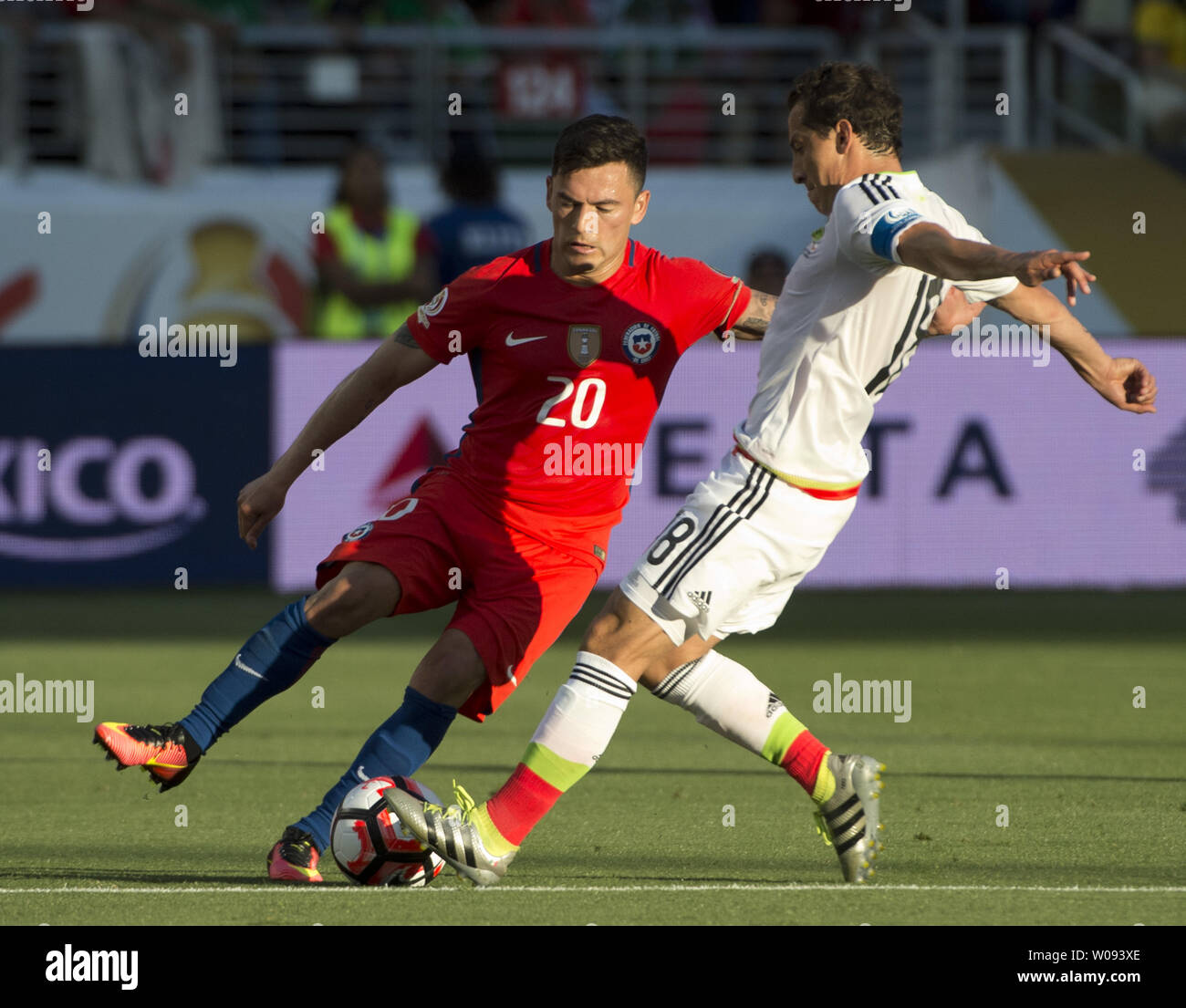 Chile's Charles Aranguz (20) and Mexico's Andres Guardado (18) battle for the ball in the first half at COPA America Centenario quarter-finals at Levi's Stadium in Santa Clara, California on June 18,  2016. Chile annihilated Mexico 7-0.   Photo by Terry Schmitt/UPI Stock Photo