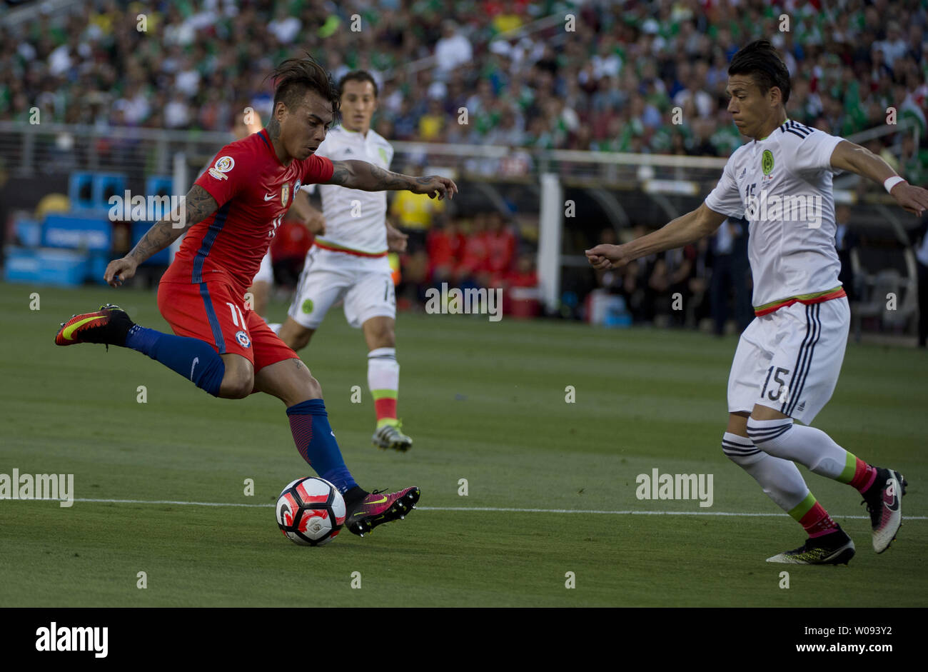 Chile's Eduardo Vargas (11) moves the ball against Mexico's Hector Moreno (15) in the first half as a Mexico fan covers her face at COPA America Centenario quarter-finals at Levi's Stadium in Santa Clara, California on June 18,  2016. Vargas had four goals as Chile annihilated Mexico 7-0.   Photo by Terry Schmitt/UPI Stock Photo