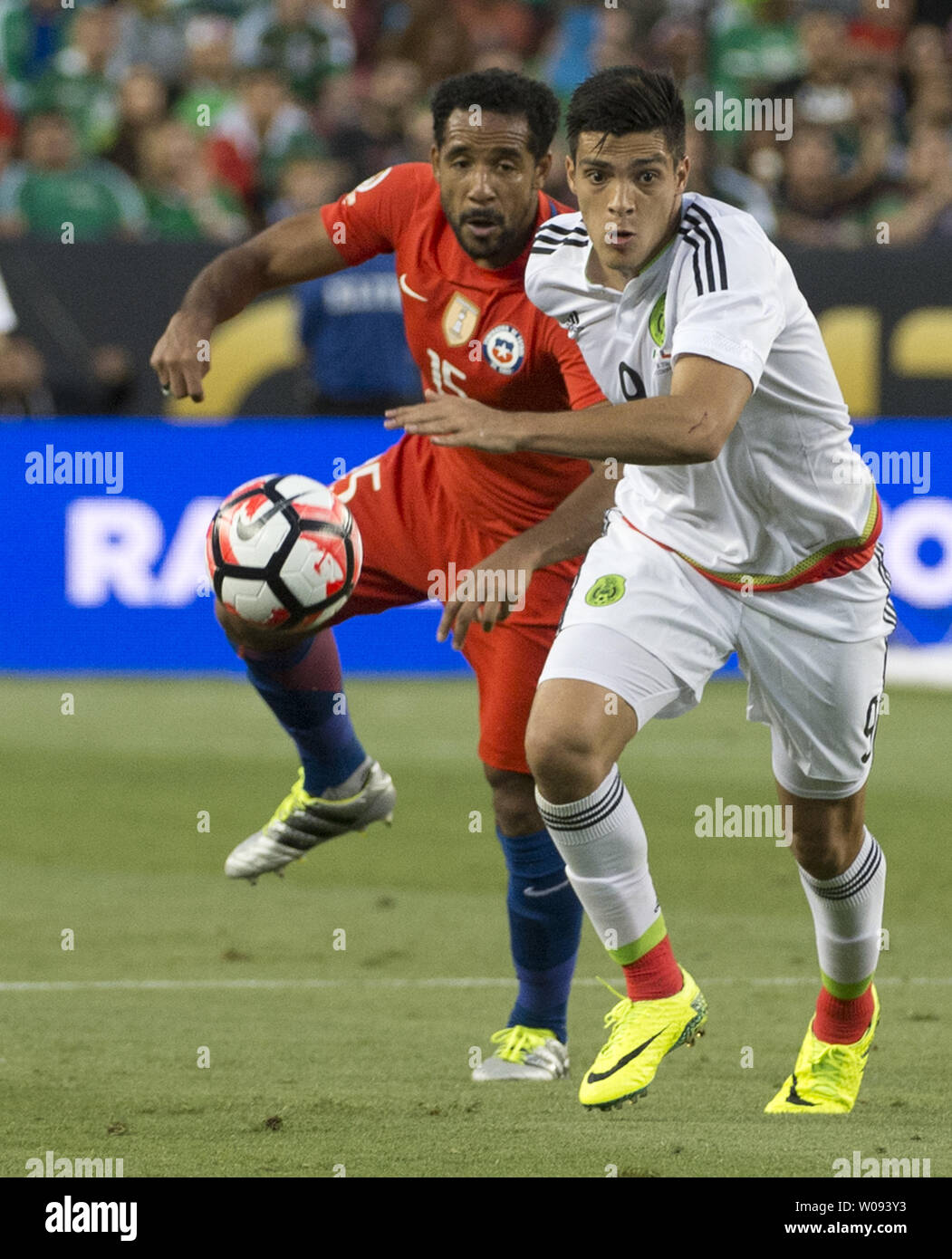 Mexico's Raul Jimenez (R) moves the ball past Chile's Jean Beausejour in the second half at COPA America Centenario quarter-finals at Levi's Stadium in Santa Clara, California on June 18,  2016. Chile annihilated Mexico 7-0.   Photo by Terry Schmitt/UPI Stock Photo