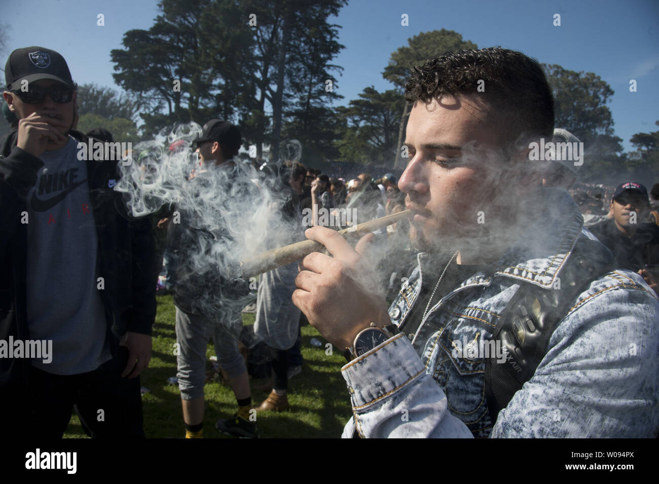 A participant puffs on an enormous joint at the first sponsored 420 event  in Golden Gate Park in San Francisco on April 20, 2017. The city fenced the  renowned Hippie Hill for
